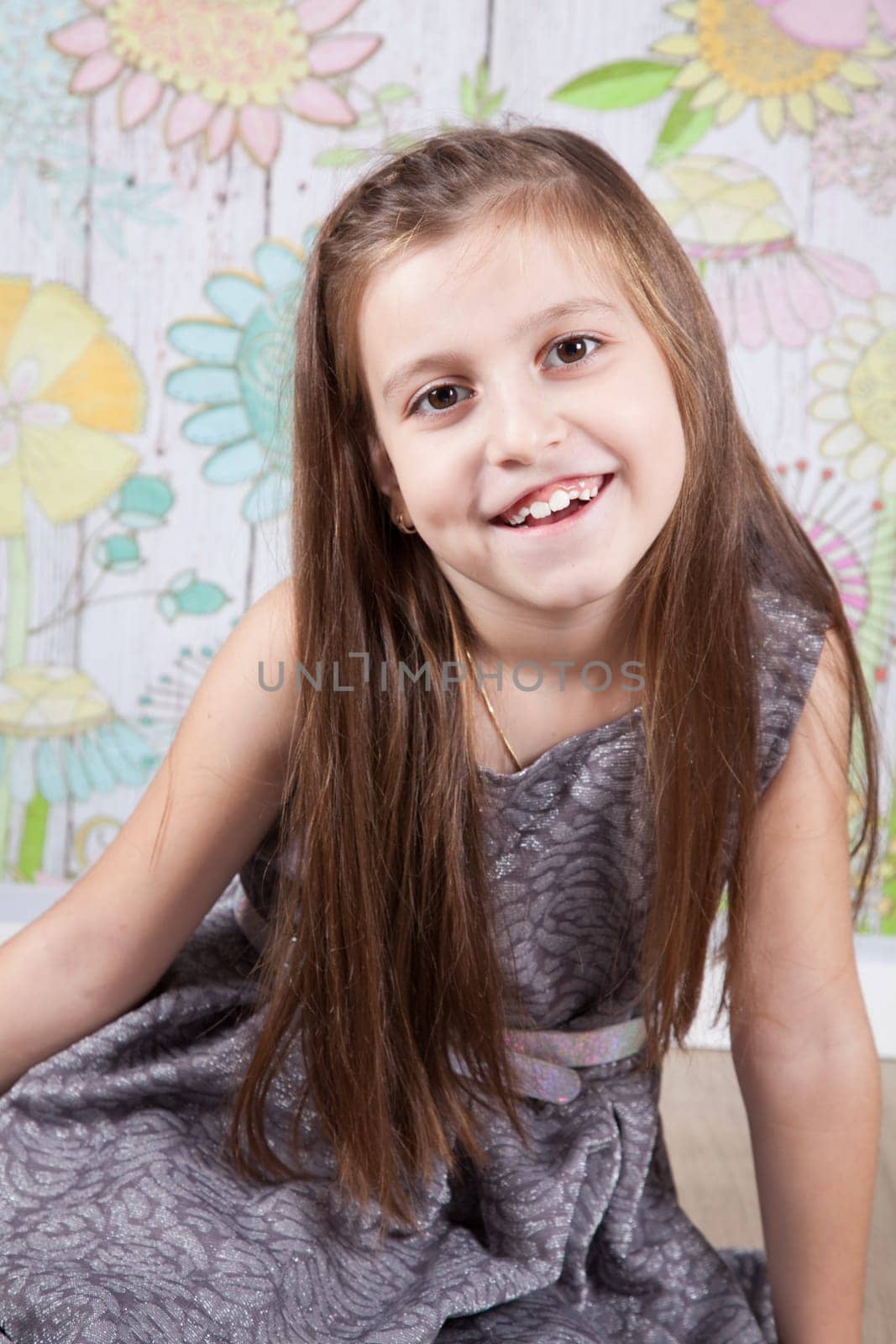 Portrait of a 8 year old girl, nicely dressed, studio shot.