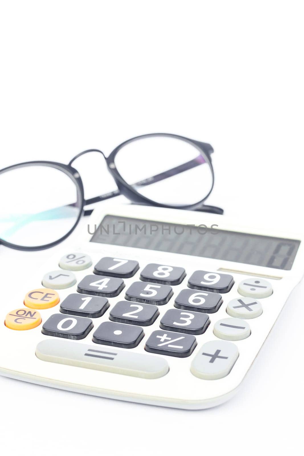 Calculator with eyeglasses isolated on white background, stock photo