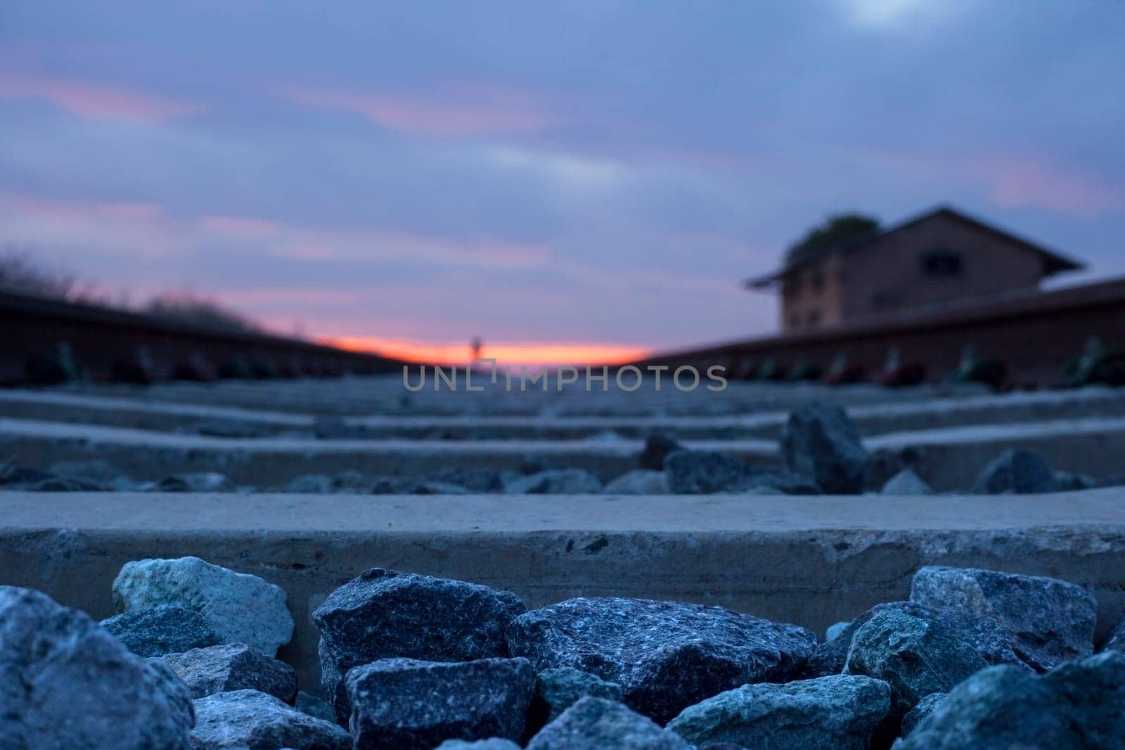 Railway tracks with abandoned rural station at dusk, Badajoz, Spain