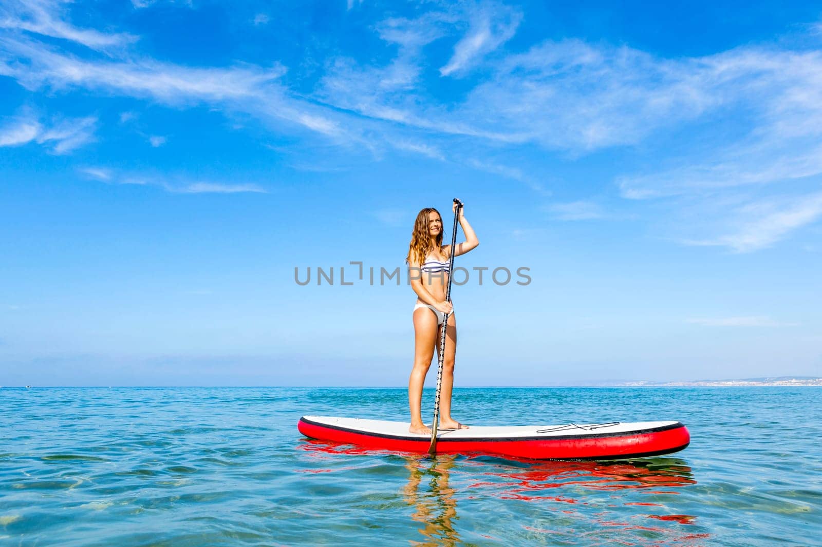 A beautiful woman practicing paddle on a beautiful sunny day
