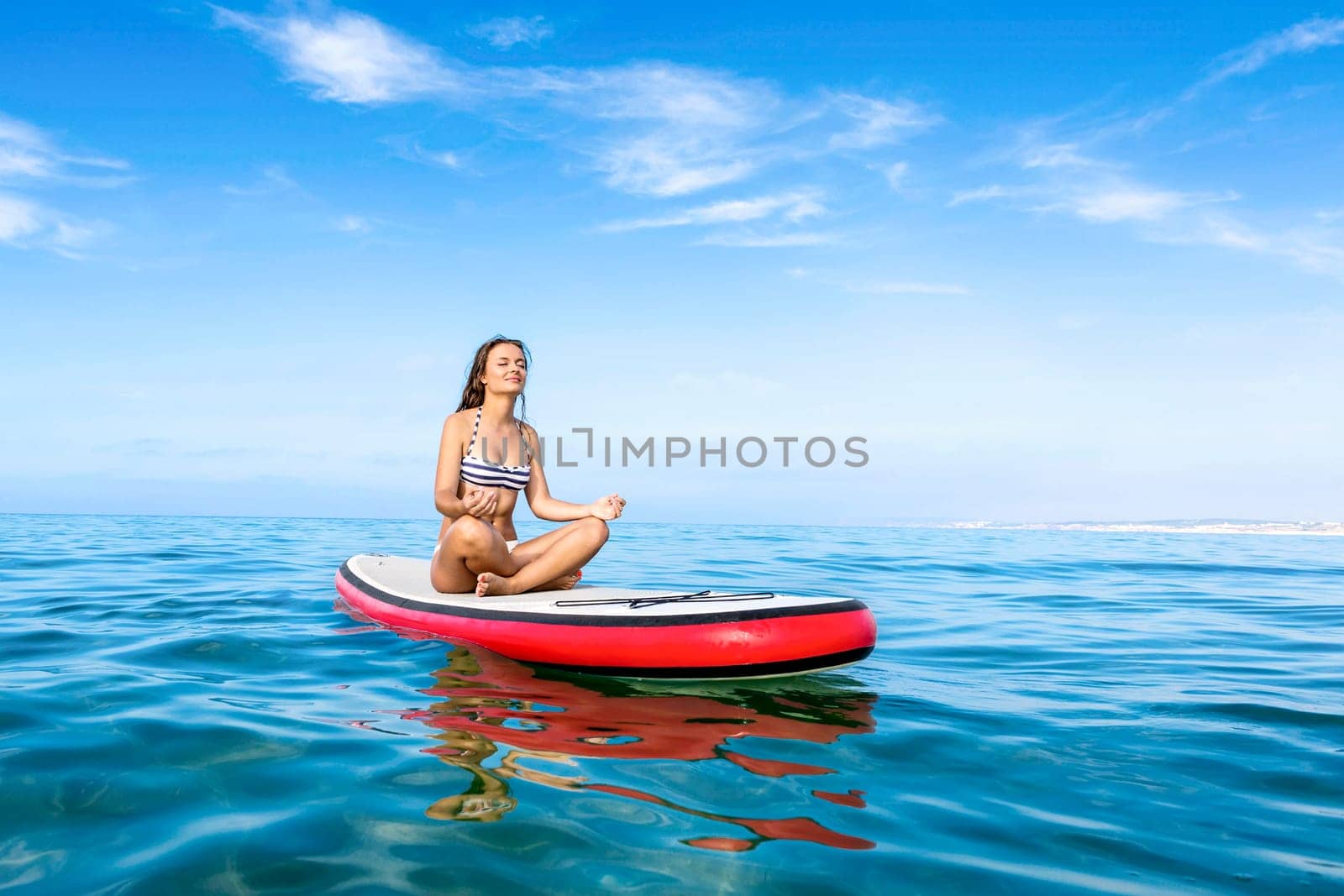 A beautiful woman practicing paddle on a beautiful sunny day