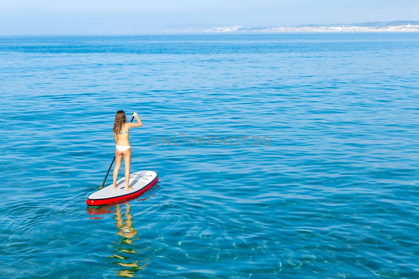A beautiful woman practicing paddle on a beautiful sunny day