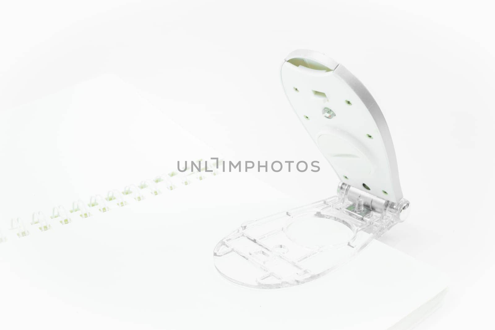 Light reading lamp clip on the paper , stock photo