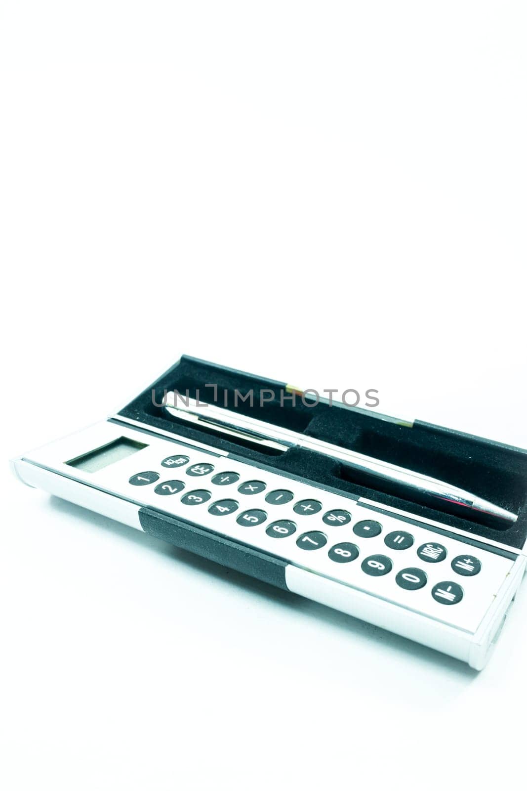 Pocket box of calculator and pen isolated on white background, stock photo