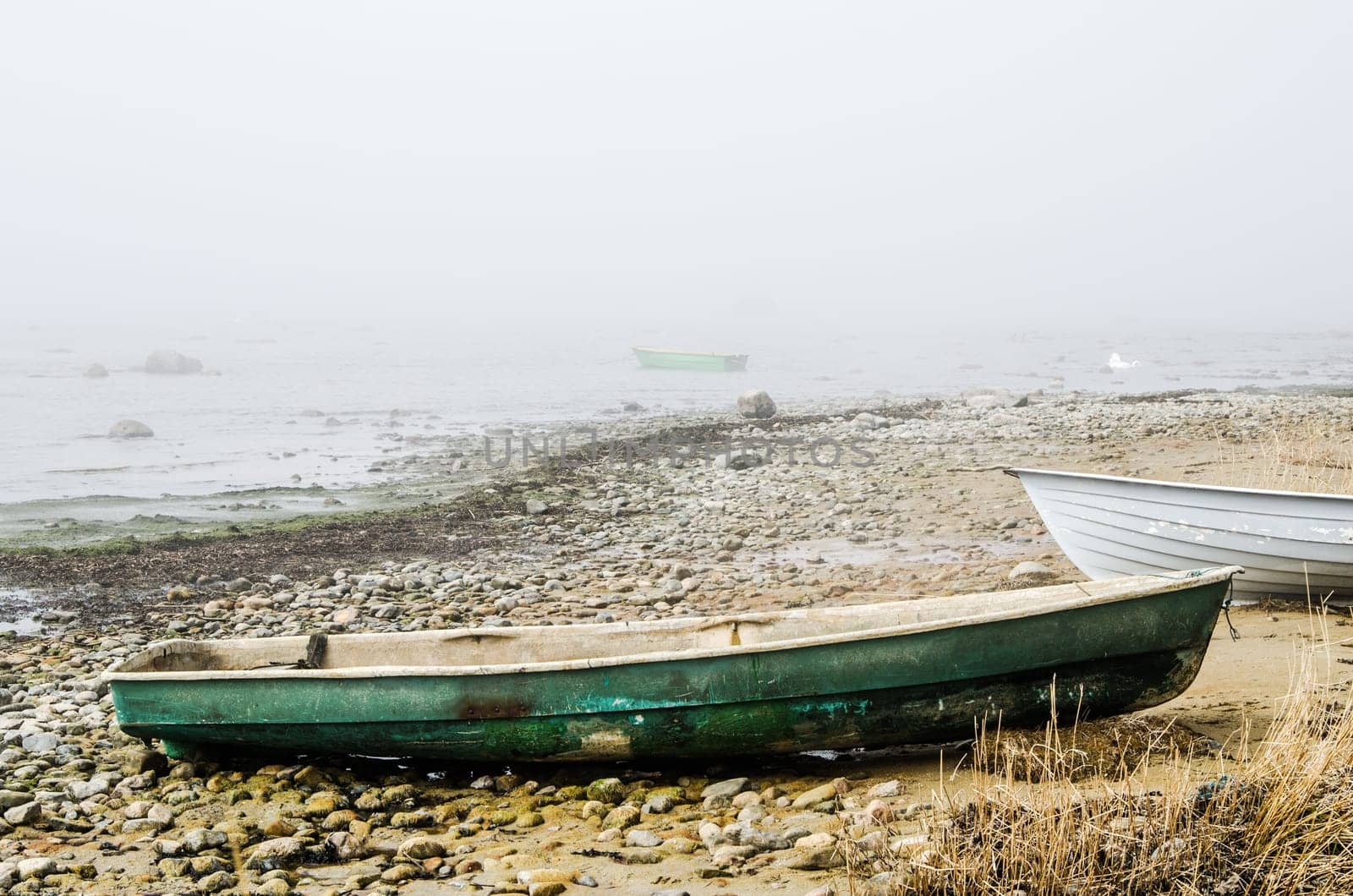 Old fishing boat at coast foggy in the morning