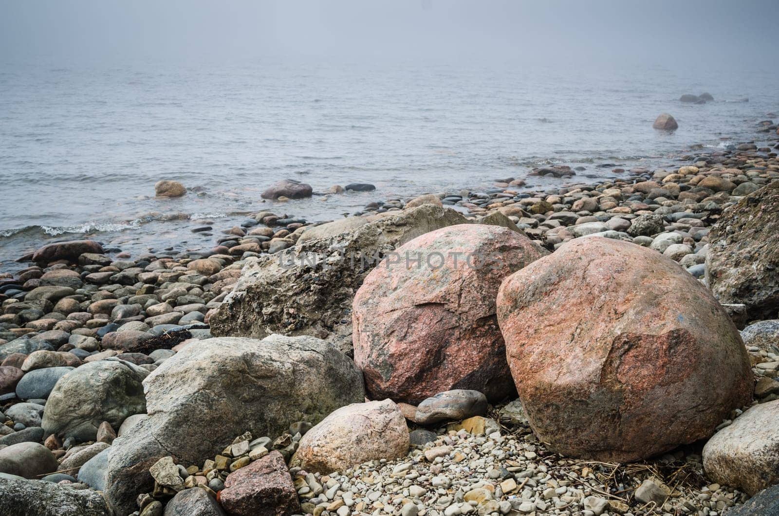 Stony coast of Baltic sea foggy in the morning