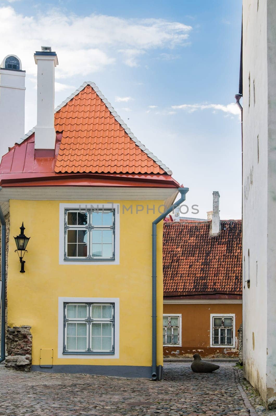Narrow street in the Old Town of Tallinn with colorful facades, Estonia