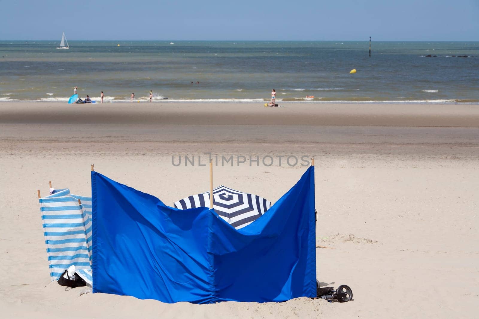 Well protected against the sun and the wind on a beach in the North of France