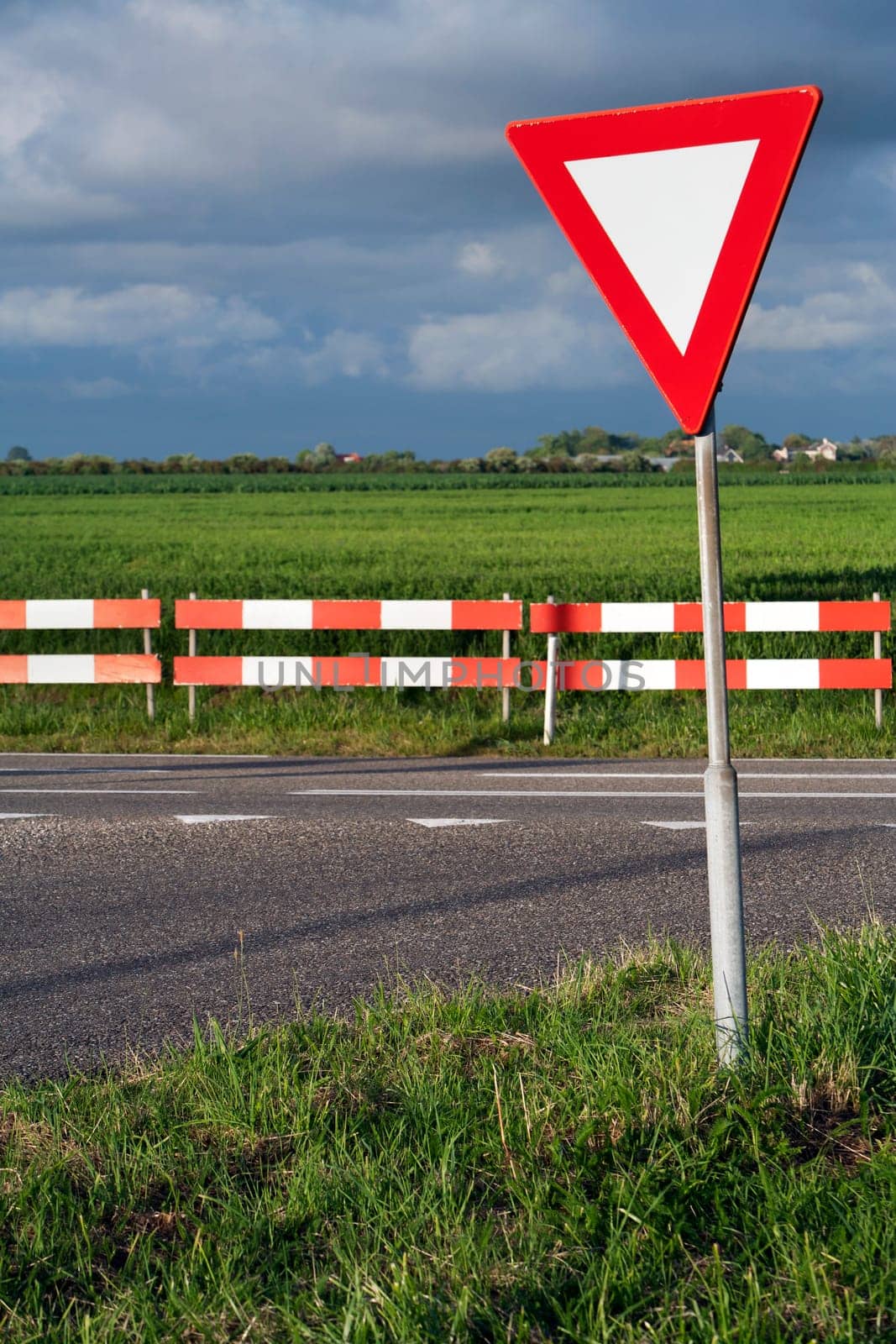 Dangerous T intersection with a road sign for give way priority yield road