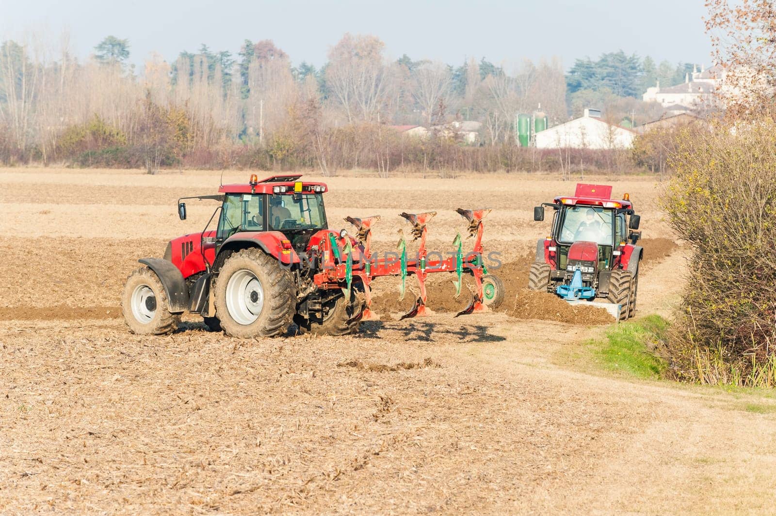 Agricultural labor, Red Tractor plowing a field