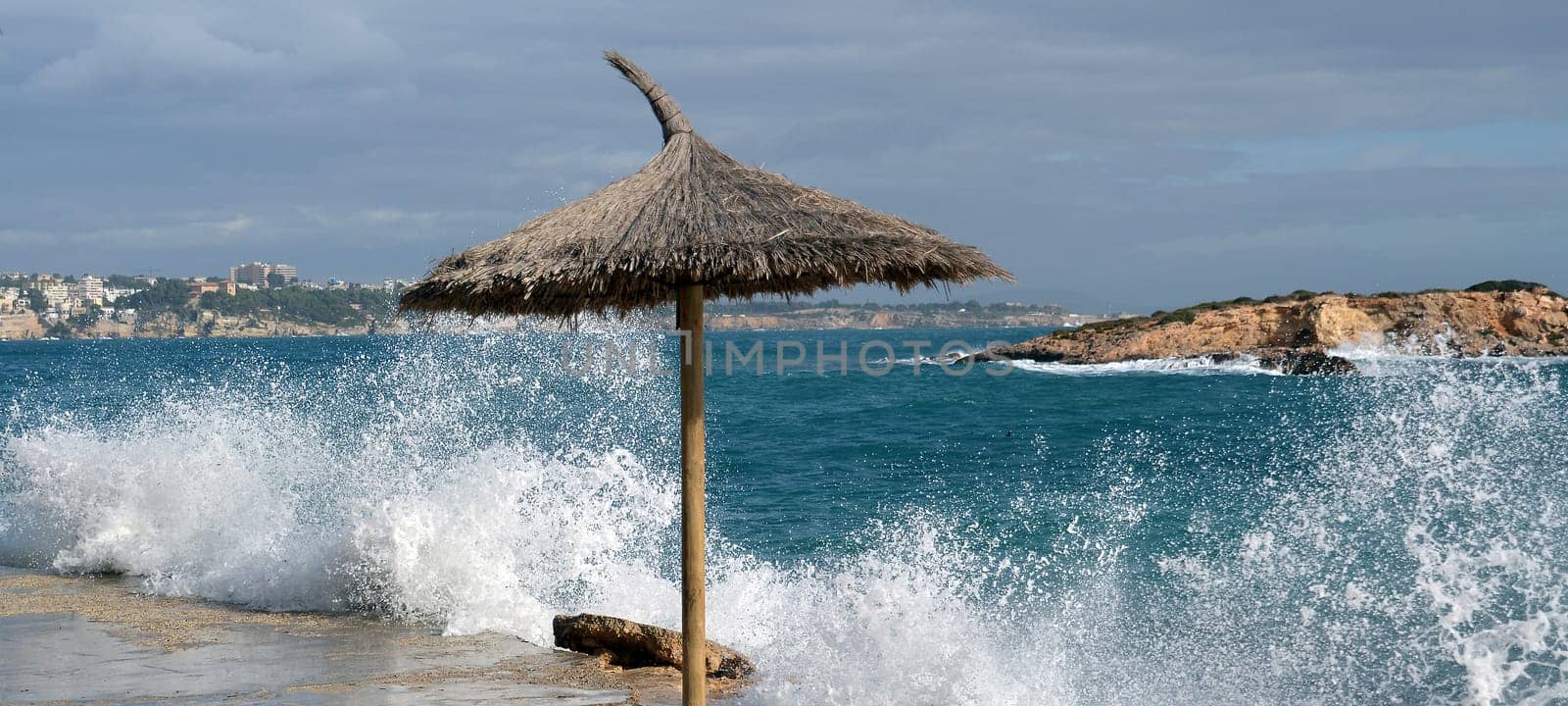 Straw umbrella by the sea