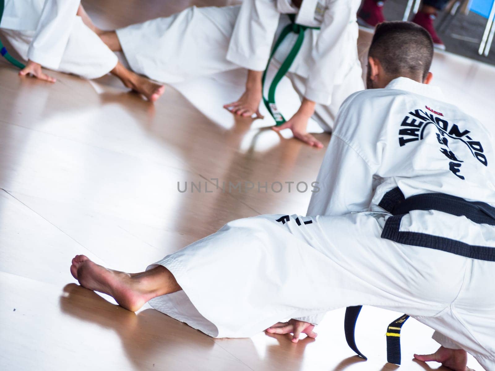 master trains his students. Training of Taekwon-do for kids