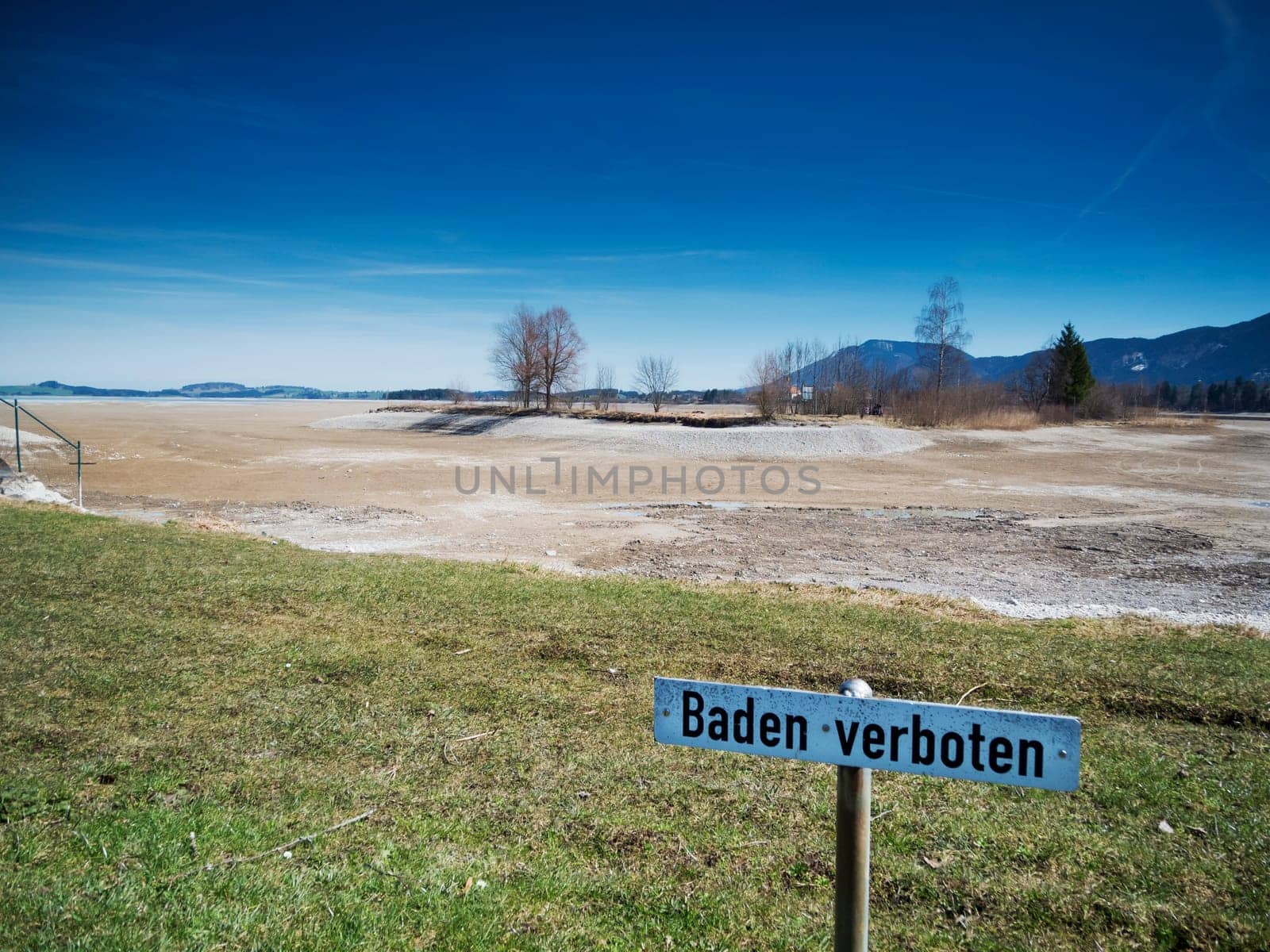 Sign with the inscription Bathing forbidden at the drained Foggensee near Füssen