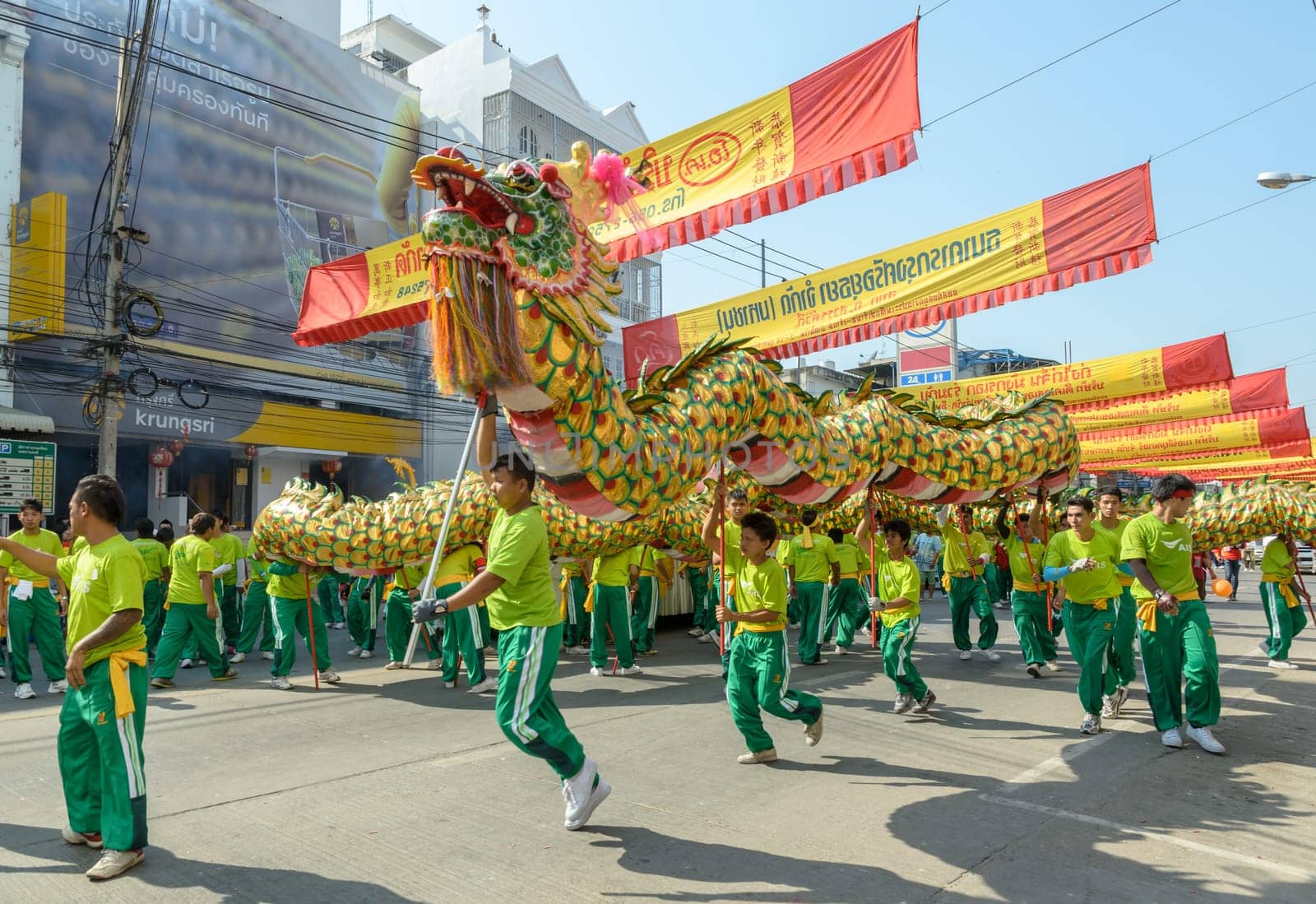 NAKHONSAWAN,THAILAND - FEBRUARY 13: Chinese New Year parade on February 13, 2013 in Nakhonsawan, Thailand. Chinese dragon dance performance for Chinese New Year Celebrations.