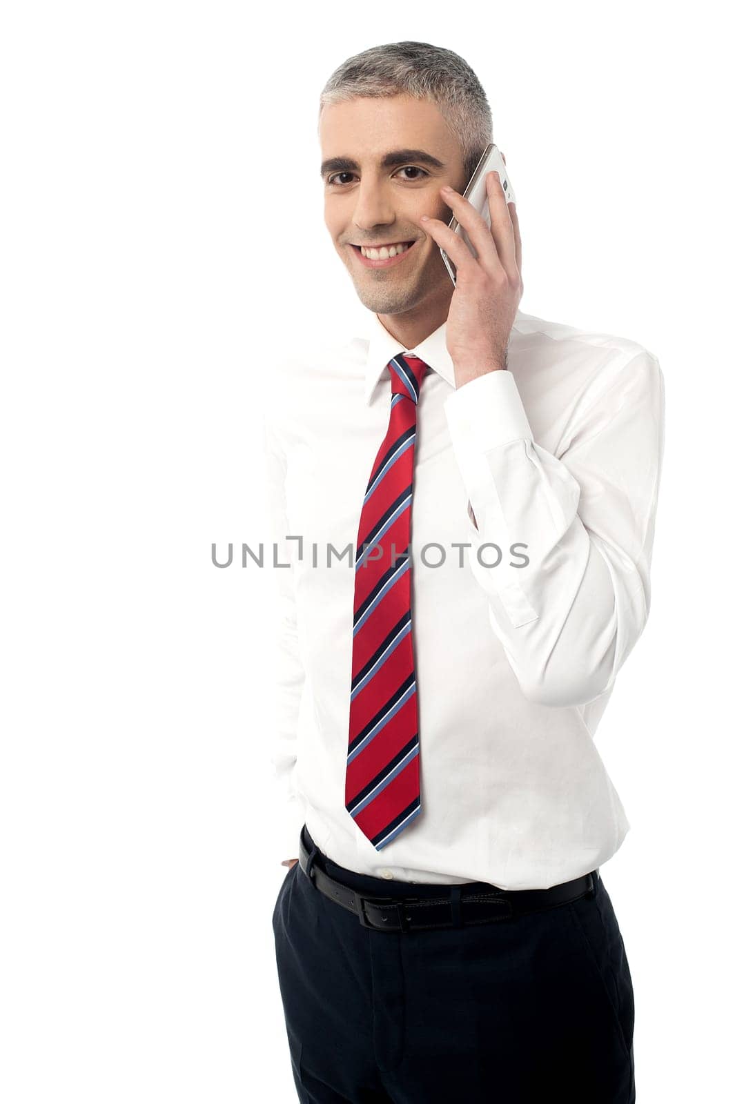 Male executive talking in mobile phone over white