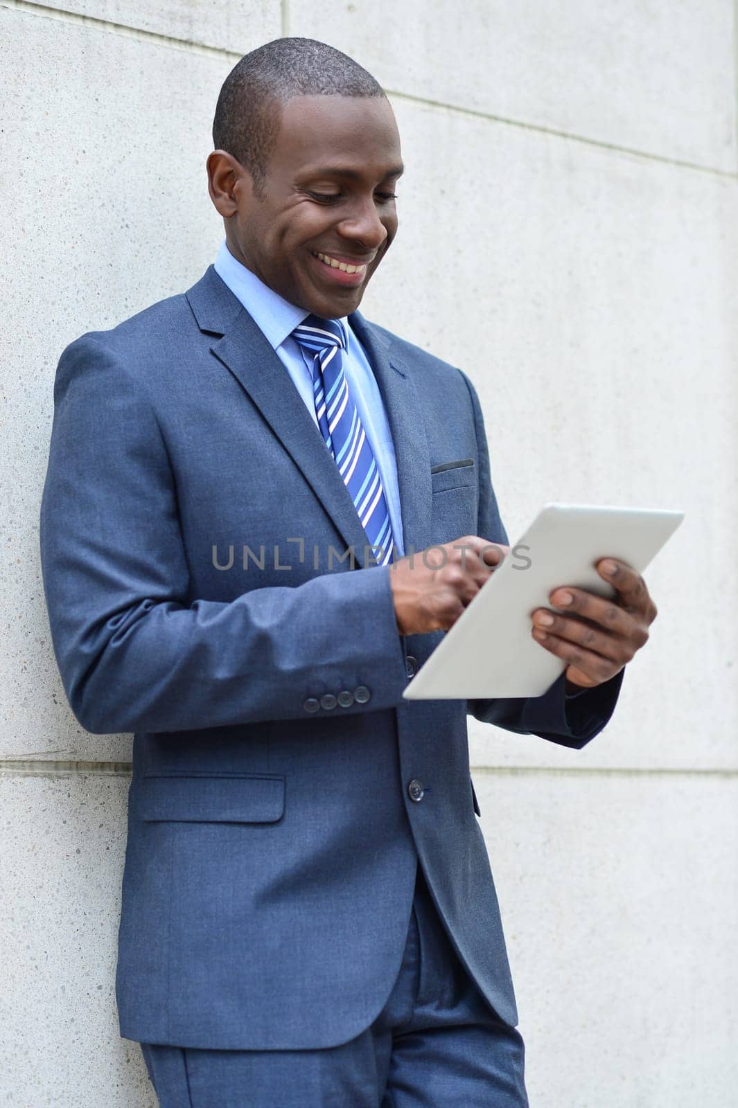 Smart business man operating his digital tablet