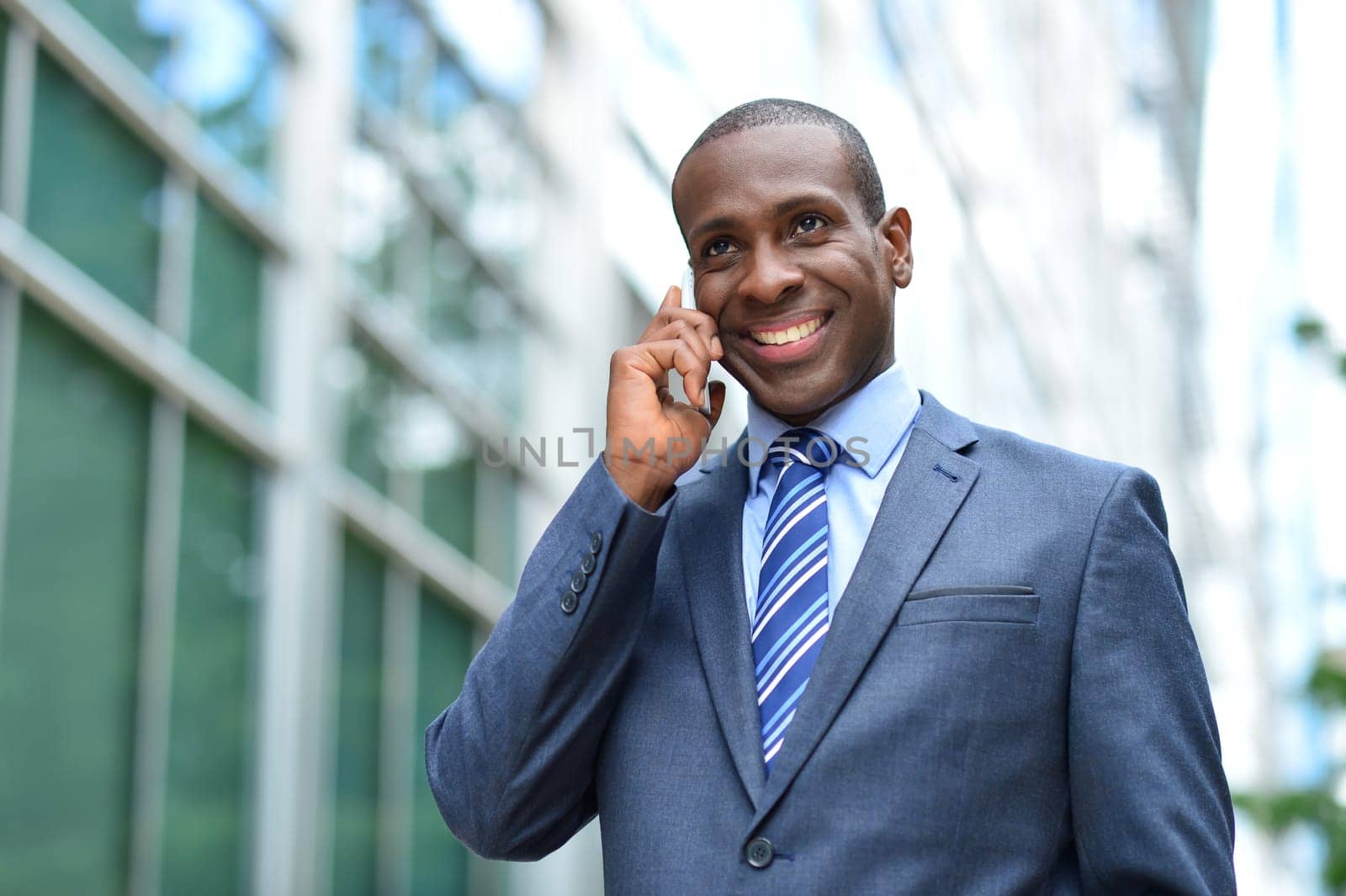 Businessman have phone conversation on office building background