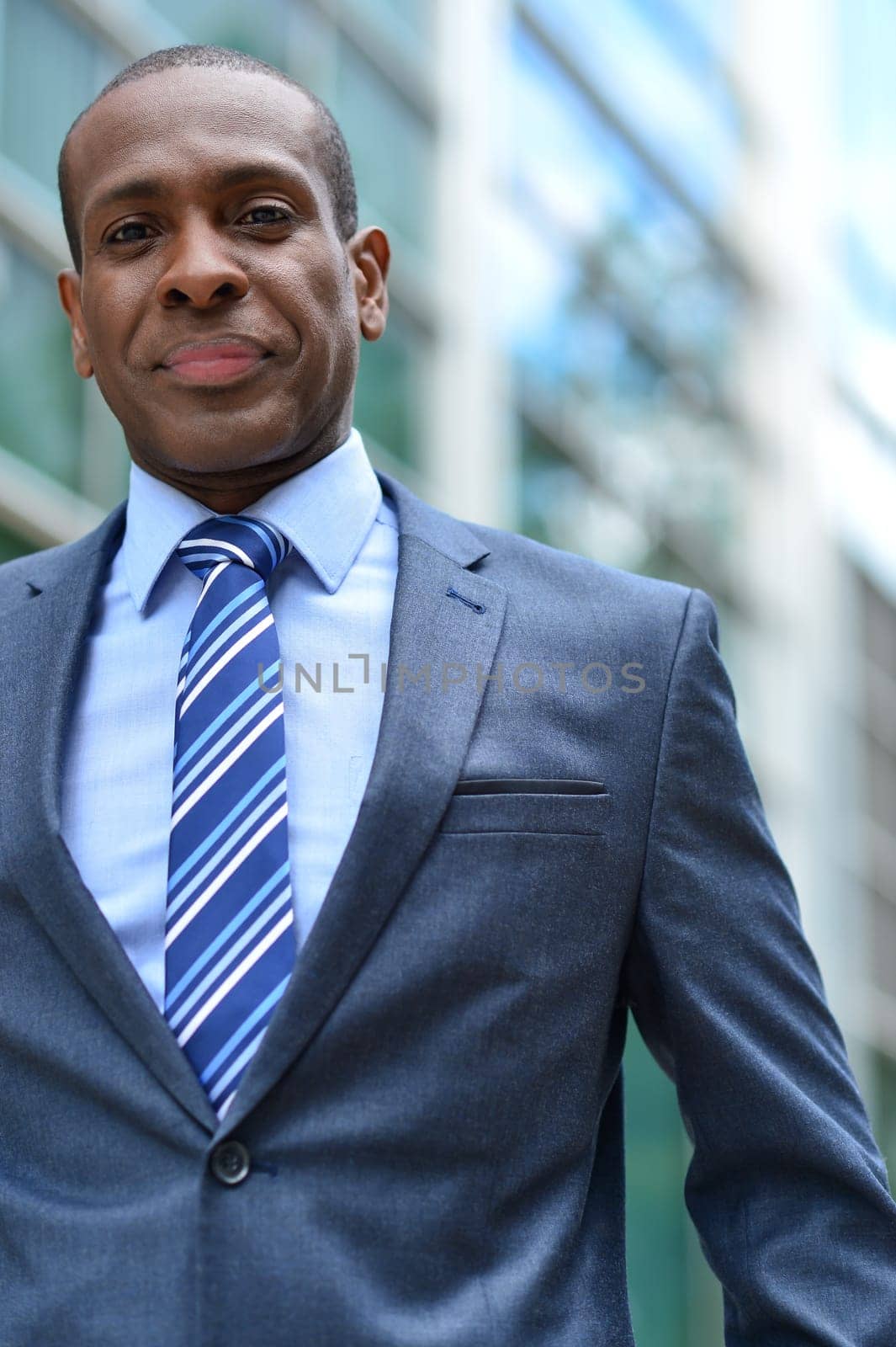 Handsome businessman posing in front of office