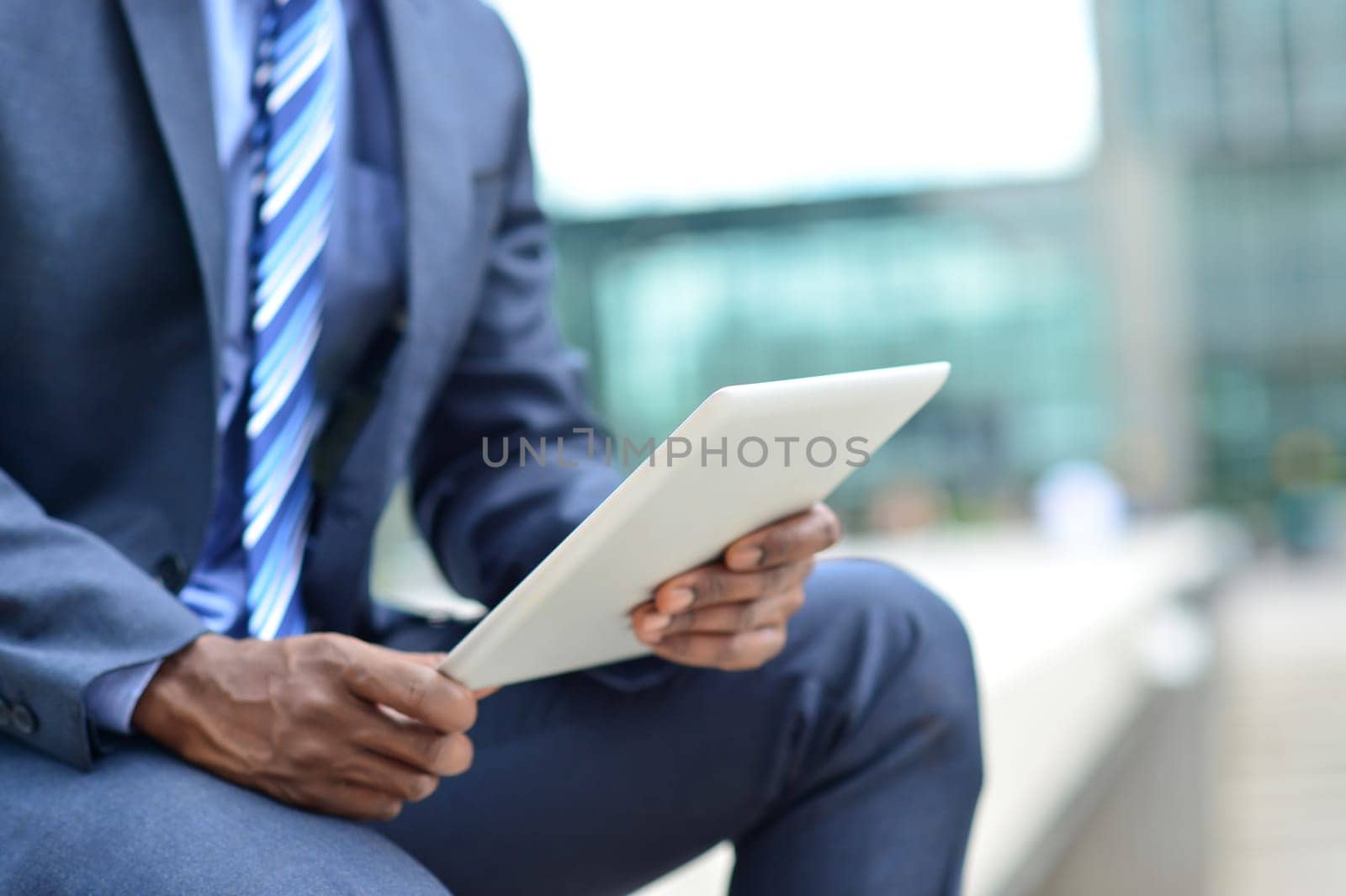 Cropped image of a business man operating tablet