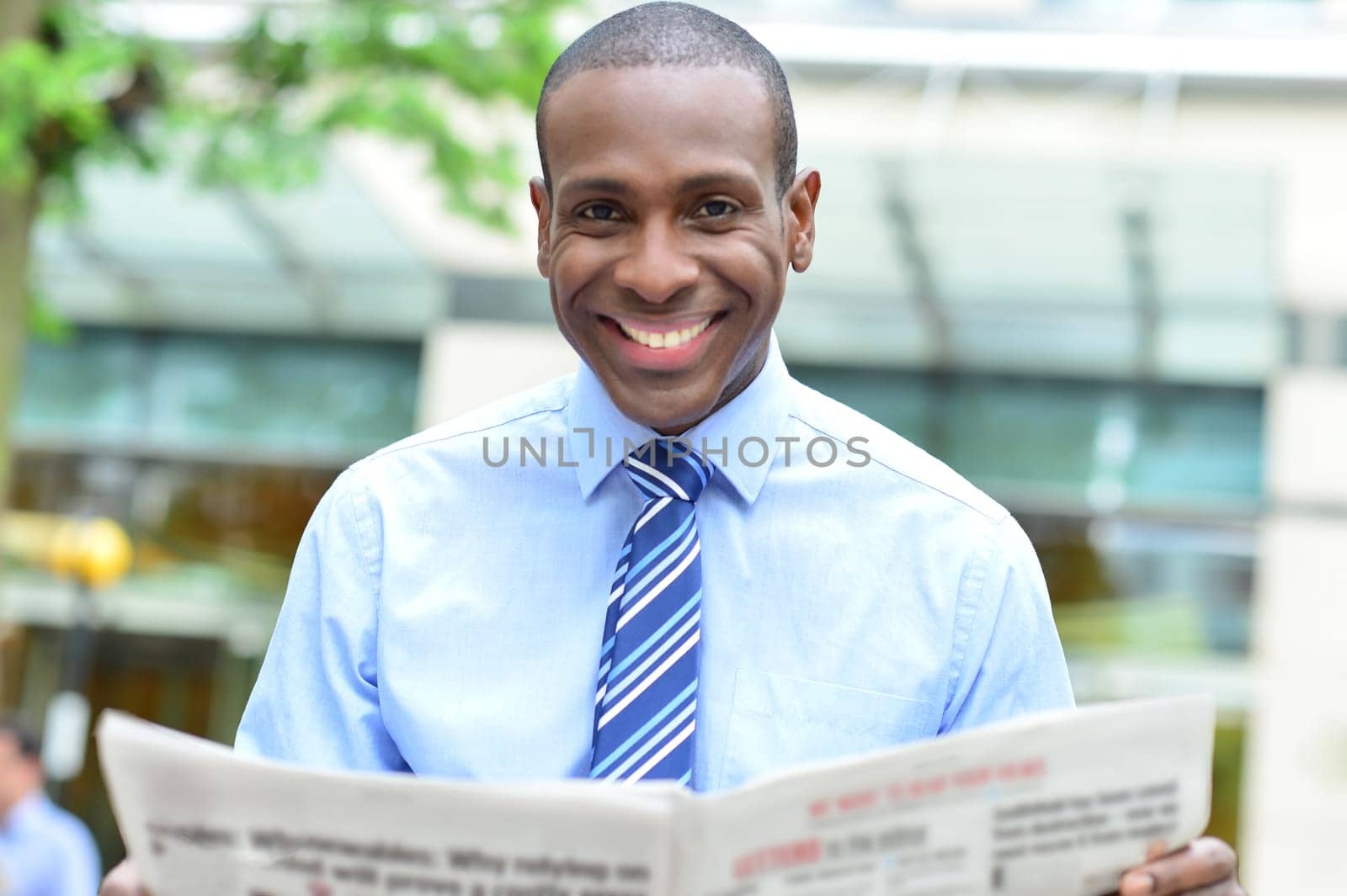 Middle aged business man smiling with magazine