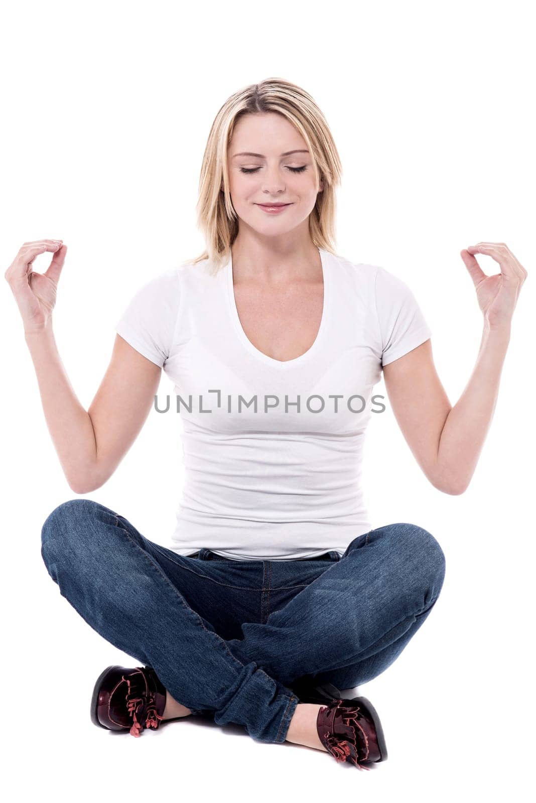 Meditating woman sitting in pose of lotus