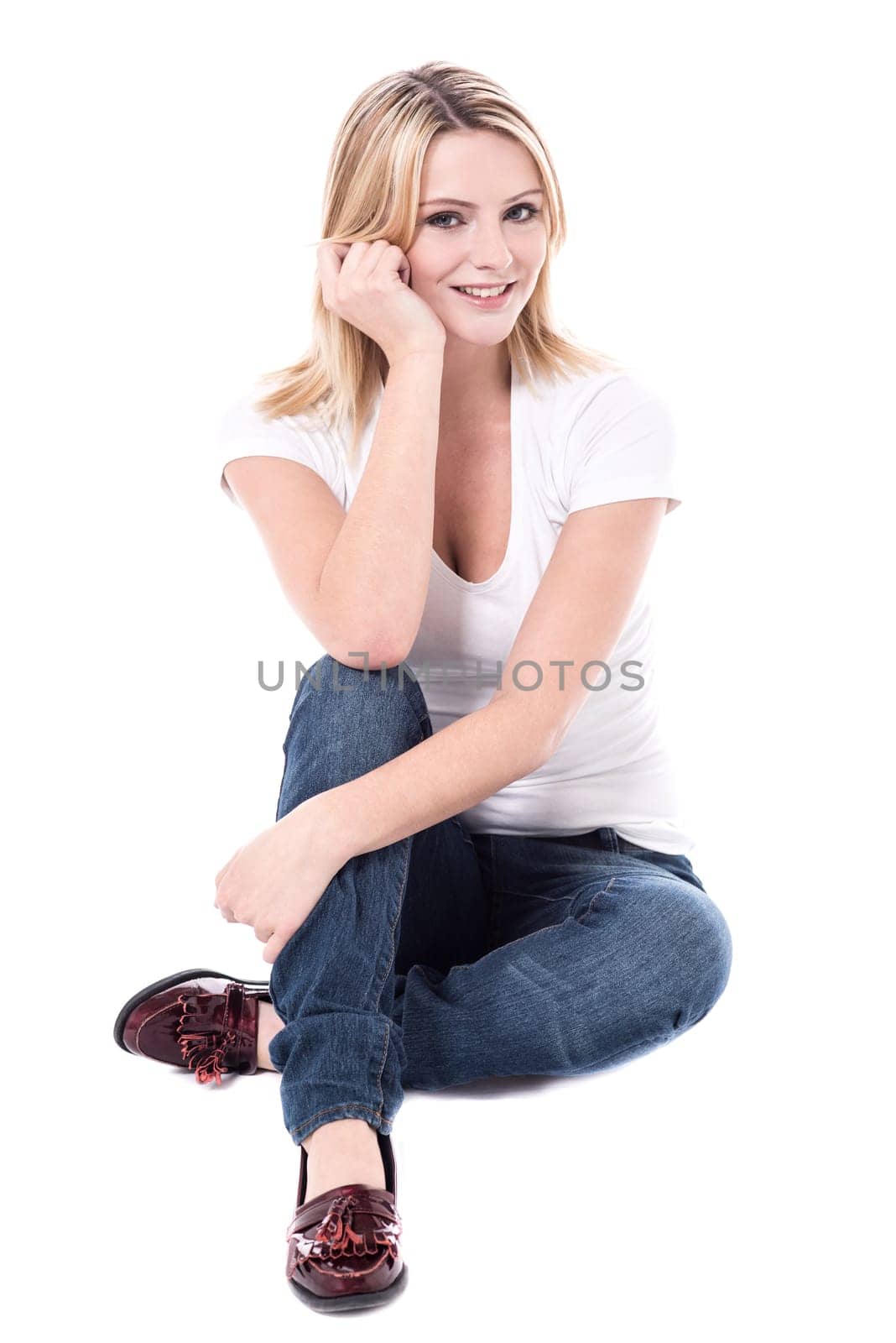 Young beautiful woman posing on white floor
