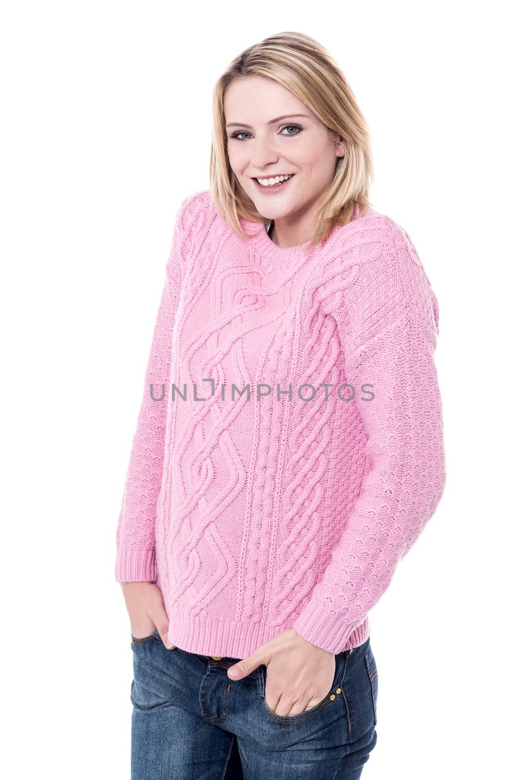 Young lady posing to camera with hands in pockets
