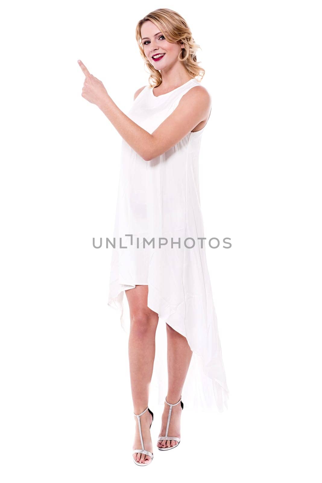 Pretty lady pointing her index finger at copy space