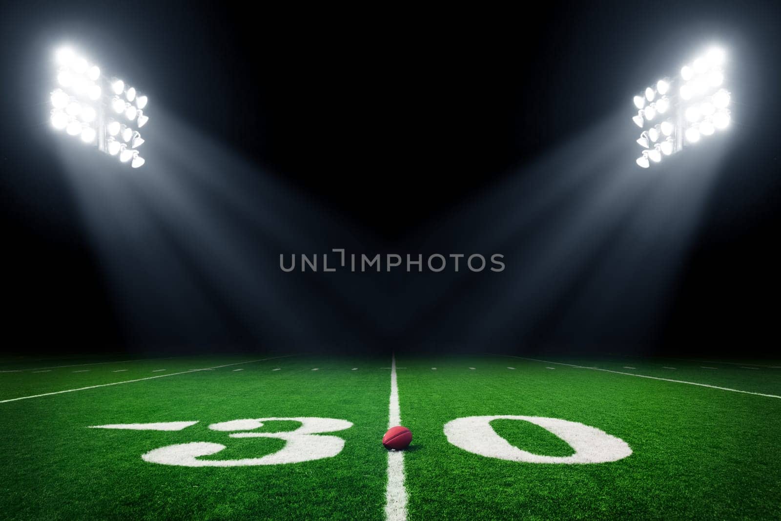 Football field illuminated by stadium lights