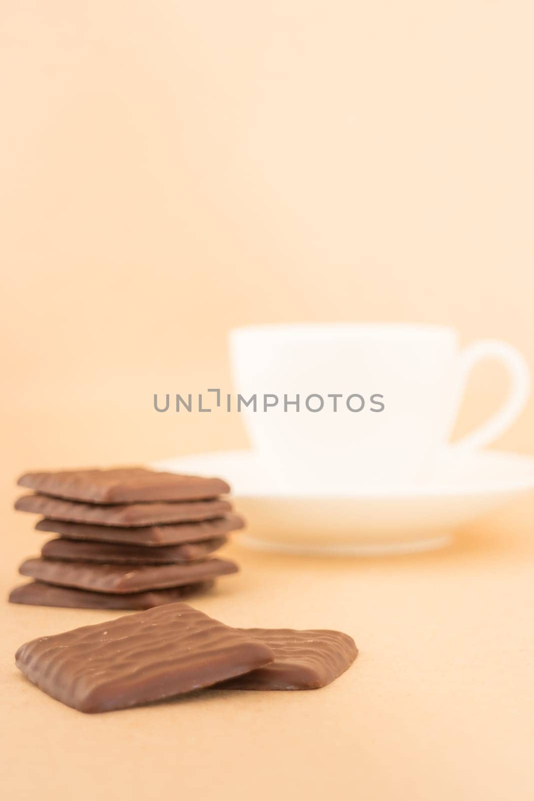 White mug of hot coffee and chocolate pieces, stock photo
