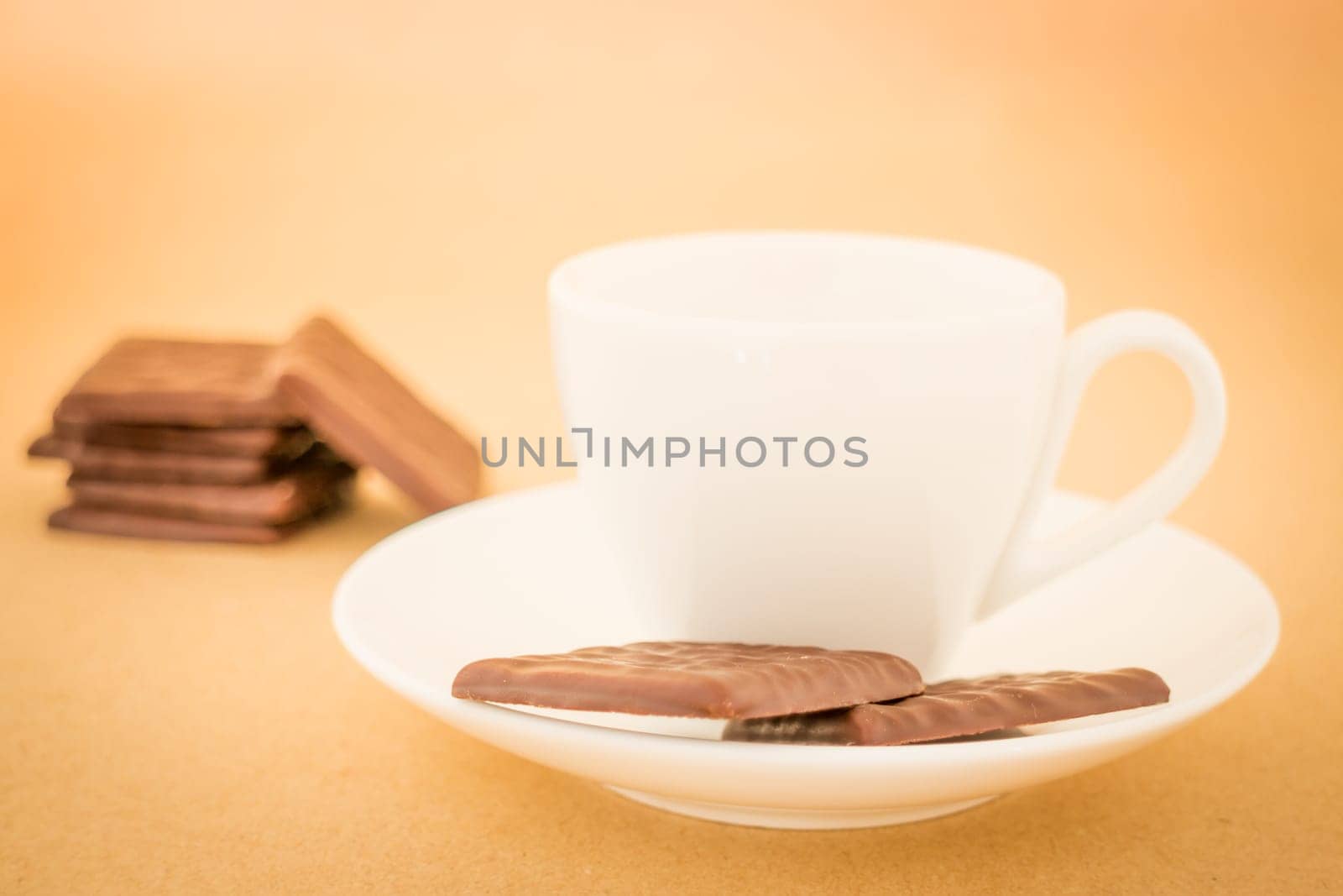 White mug of hot coffee and chocolate pieces, stock photo