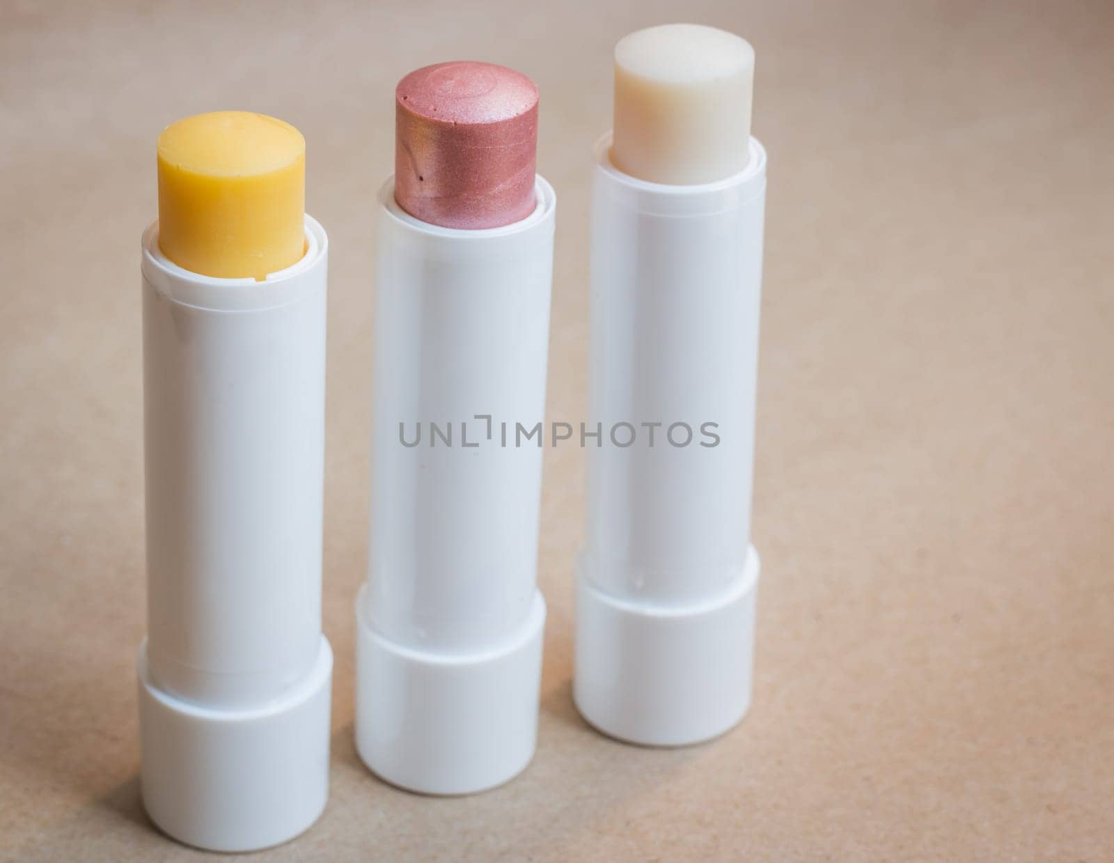 Moisturizer lipstick on brown natural background, stock photo