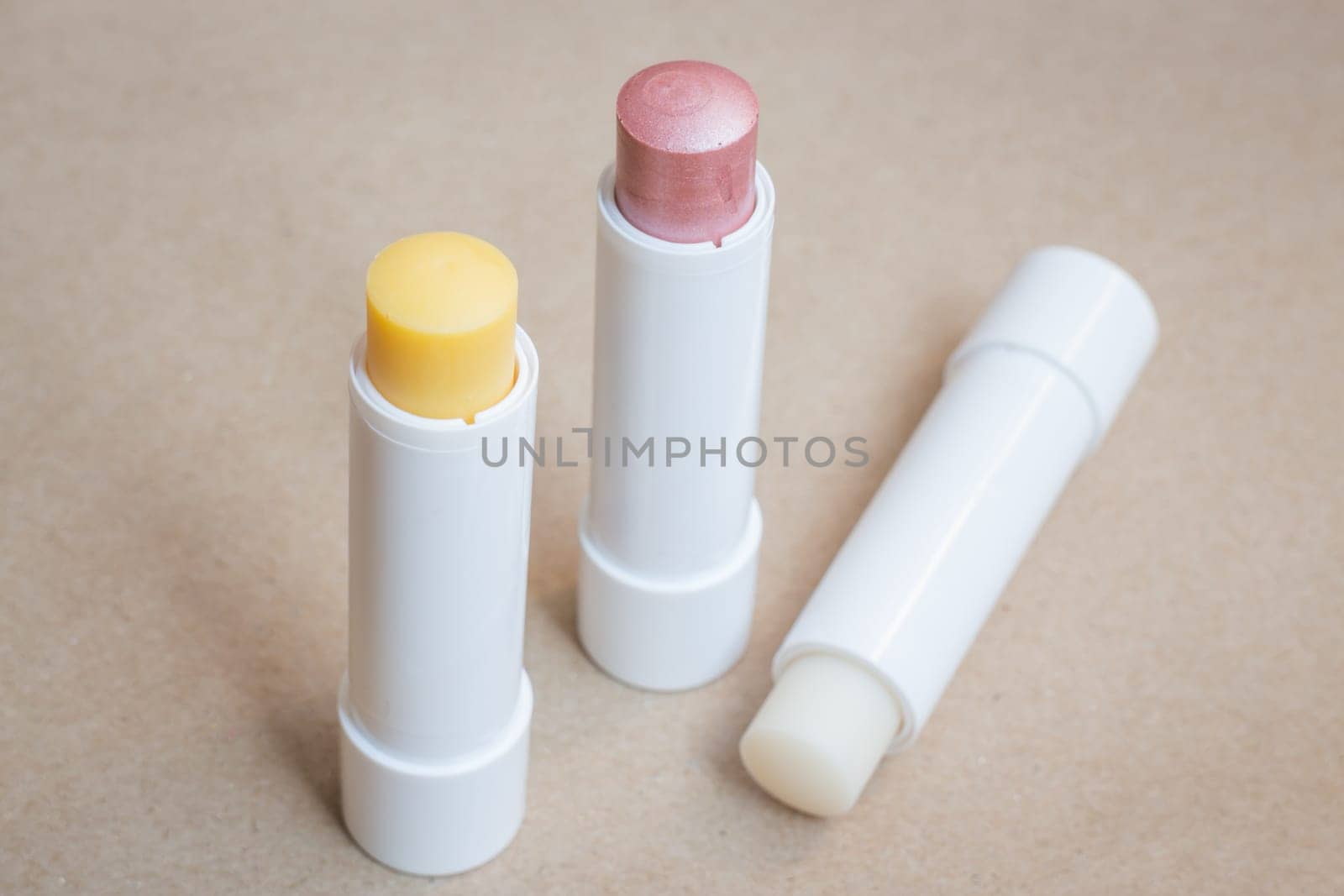 Moisturizer lipstick on brown natural background, stock photo