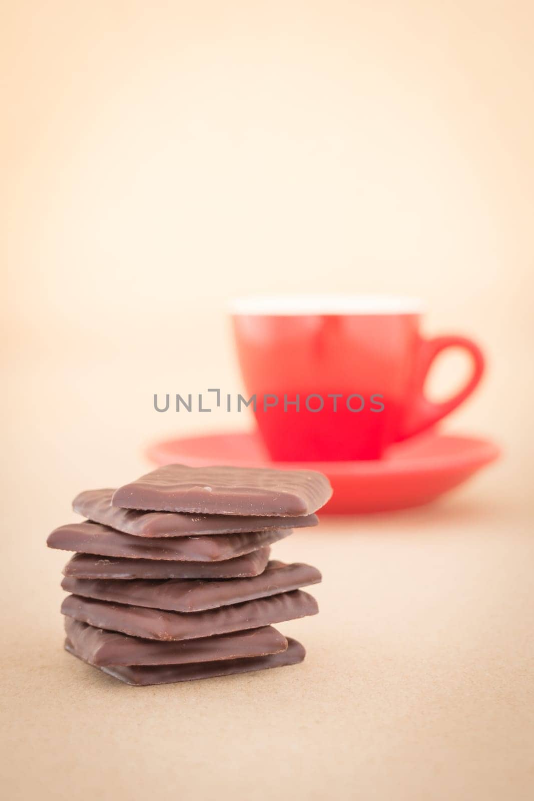 Red mug of hot coffee and chocolate pieces, stock photo