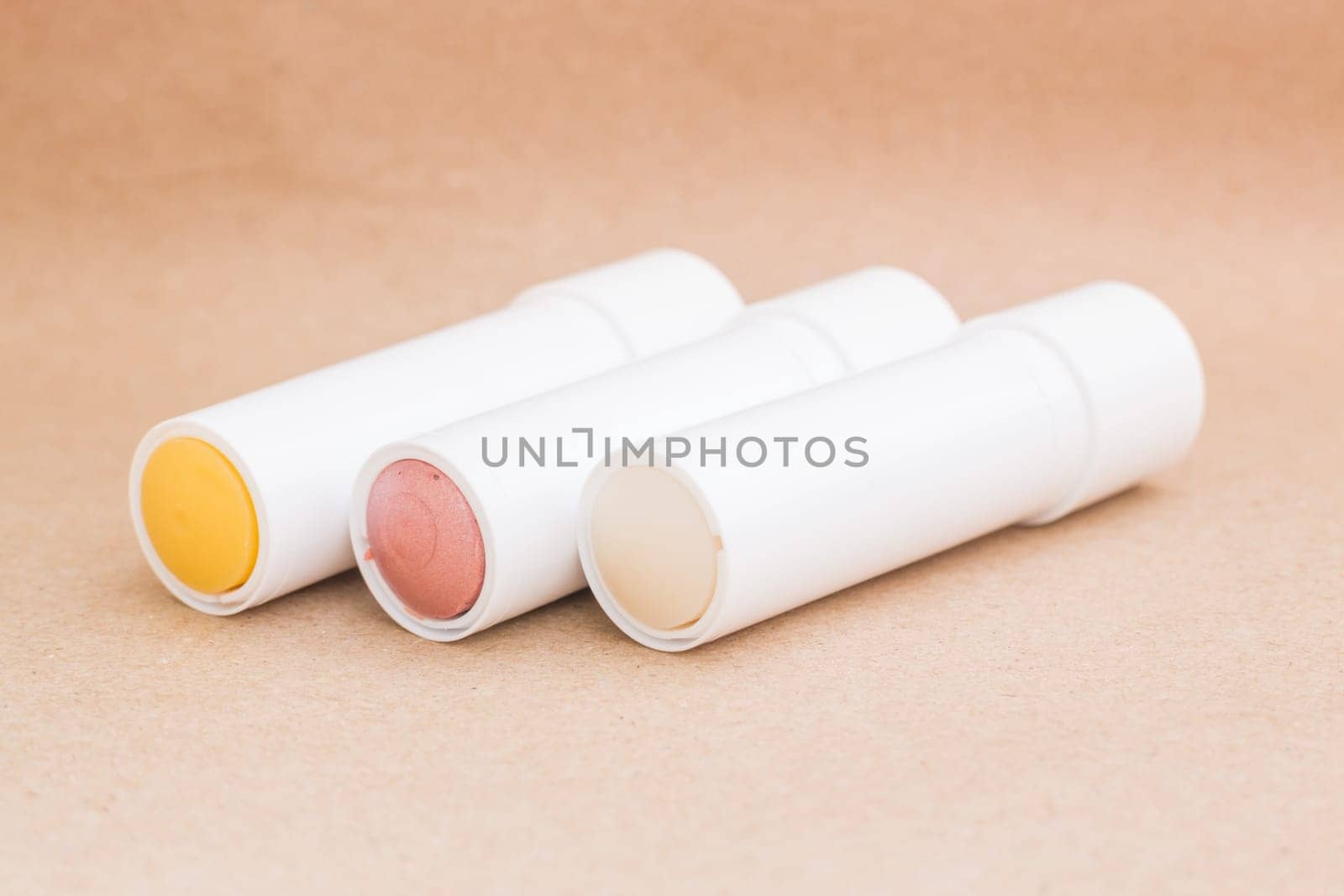 Moisturizer lipstick on brown natural background, stock photo