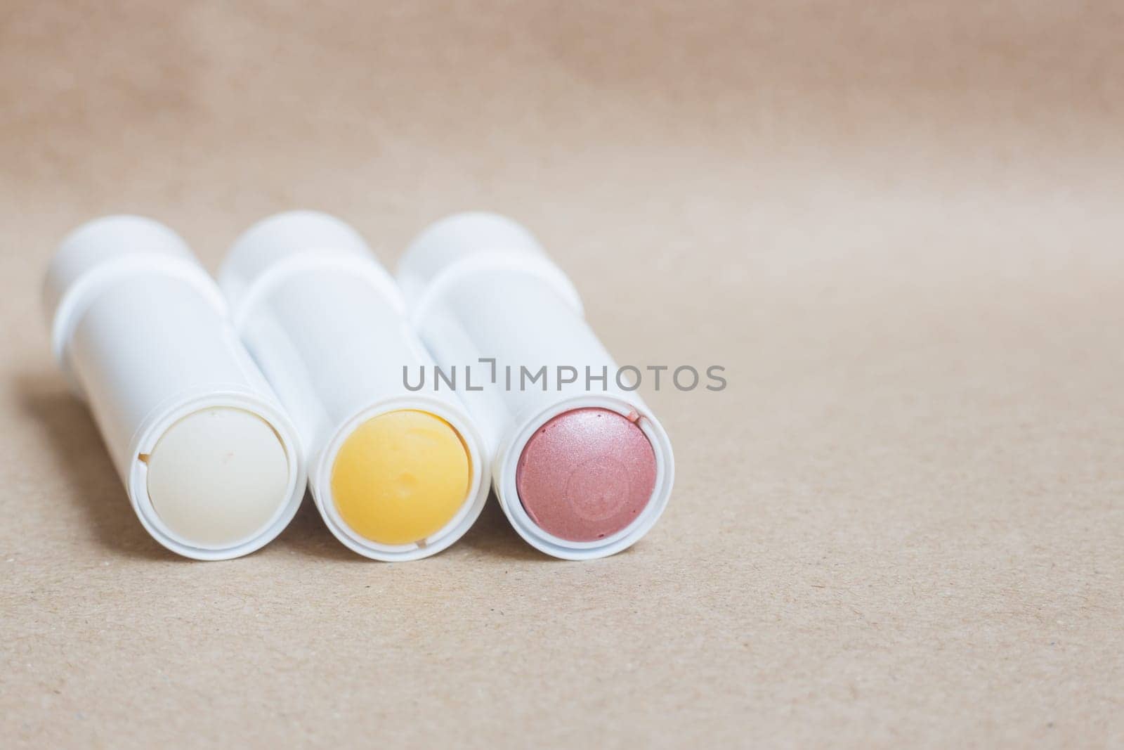Moisturizer lipstick on brown natural background, stock photo