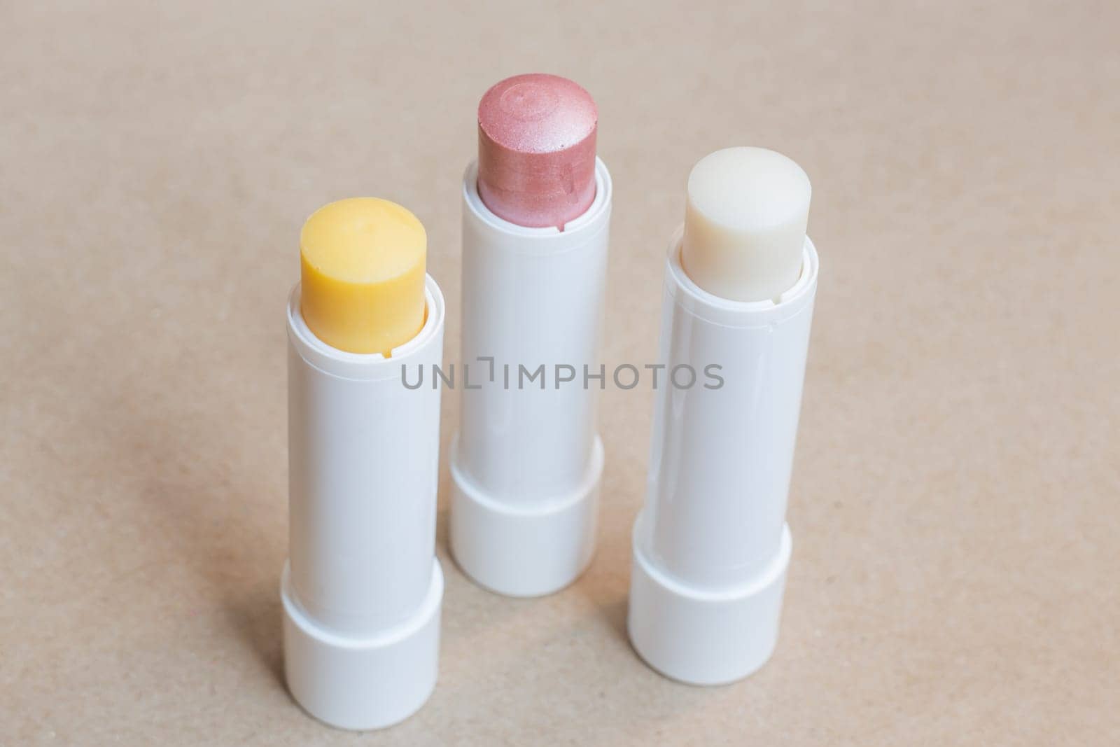 Moisturizer lipstick on brown natural background, stock photo