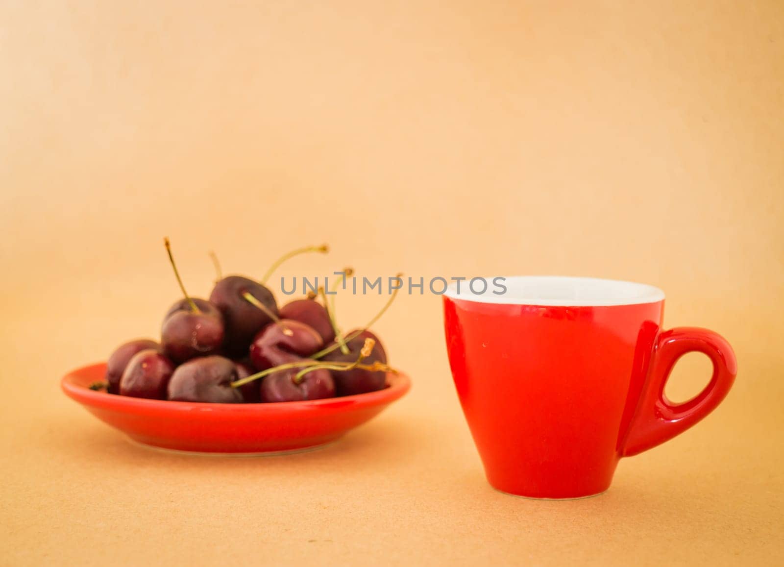 Beautiful breakfast of red coffee cup and cherries, stock photo