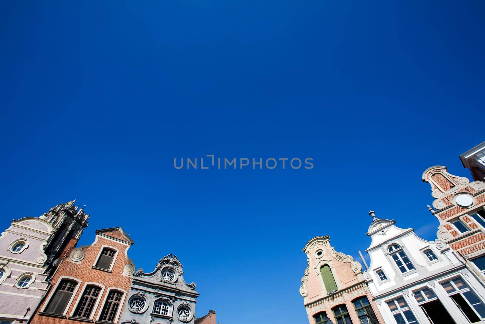 Facade of 18th century buildings at the Grote Markt (Large market square) in Mechelen, Belgium.  A blue sky makes the buildings even more attractive.