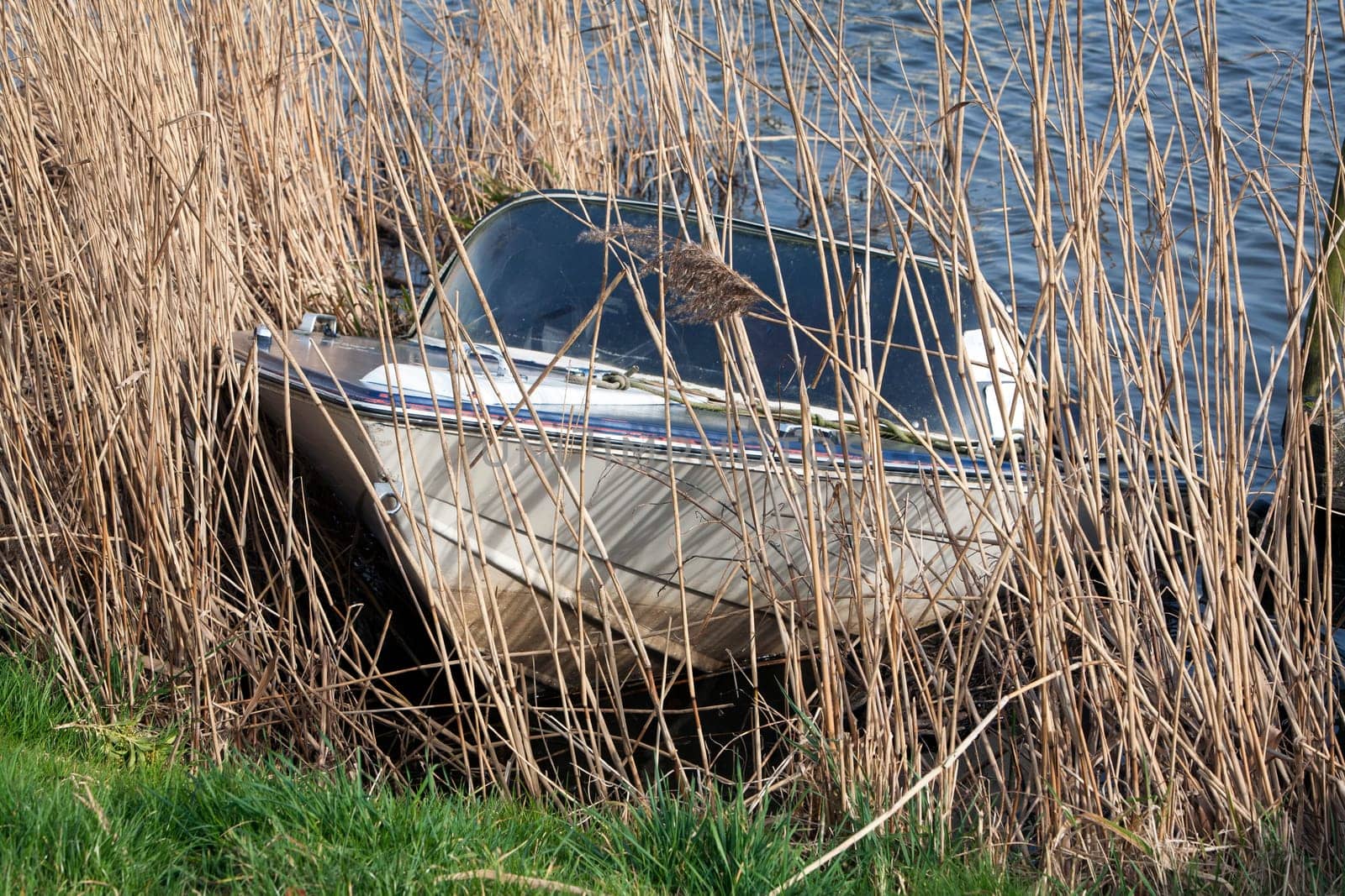Sunken recreational boat half underwater