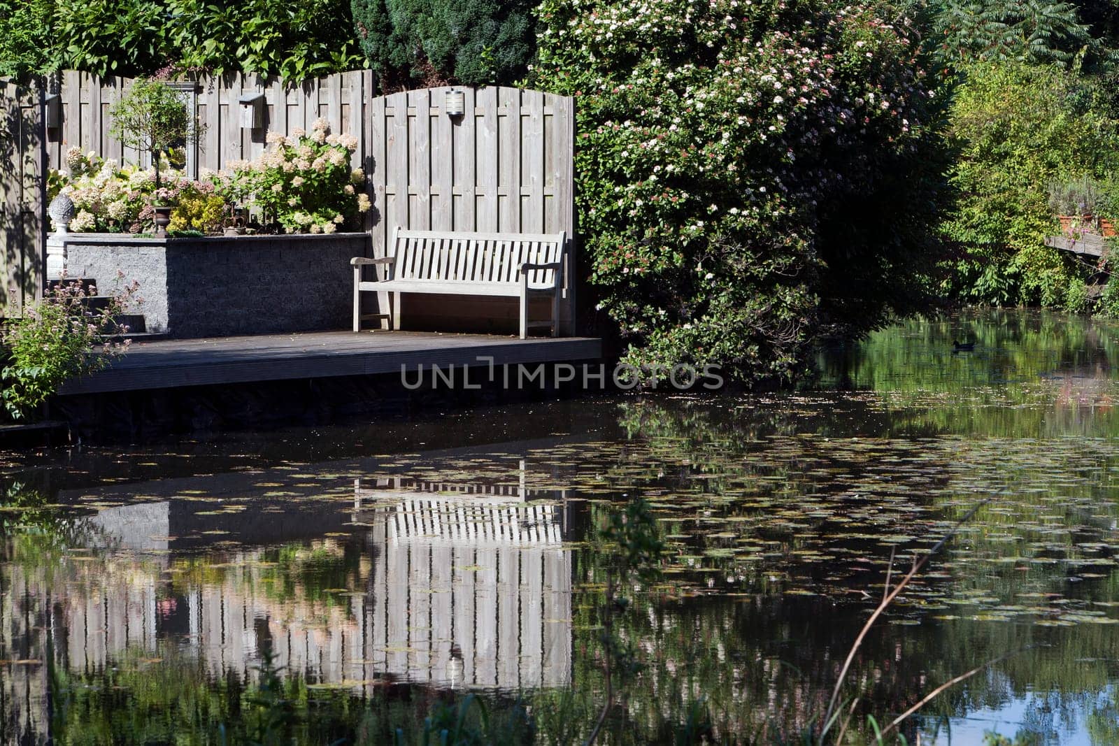 Bench at the waterfront and its reflections