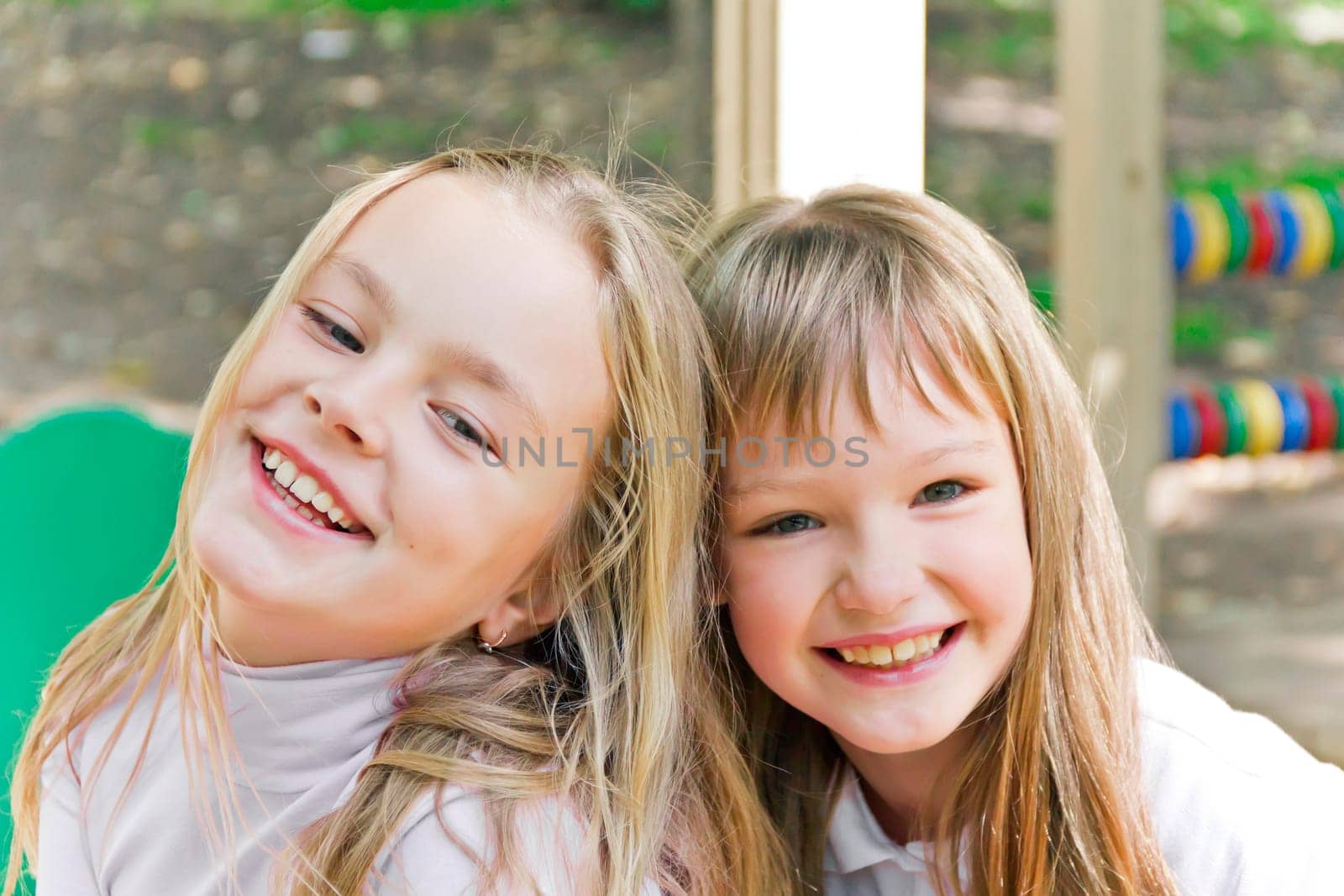 Photo of two smiling girls in summer