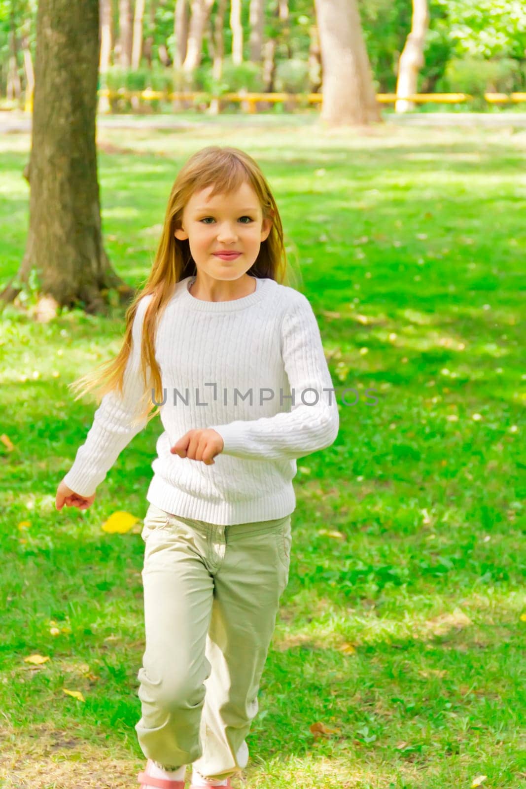 Photo of cute running girl in summer