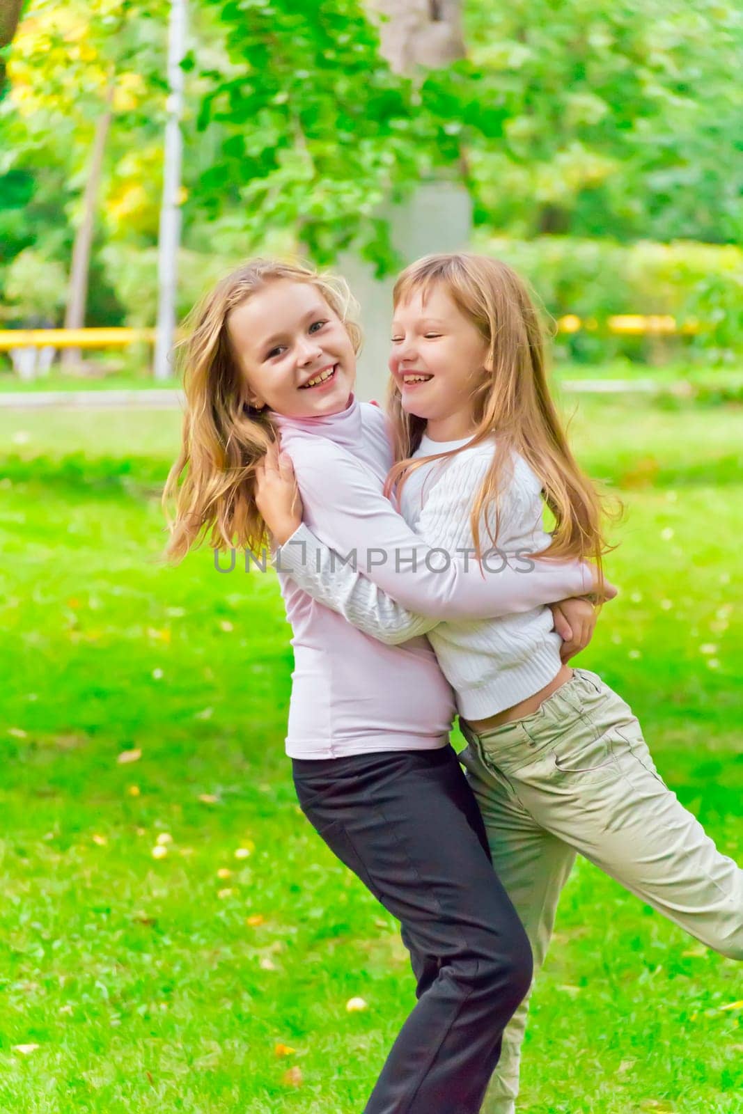 Photo of two playing girls in summer
