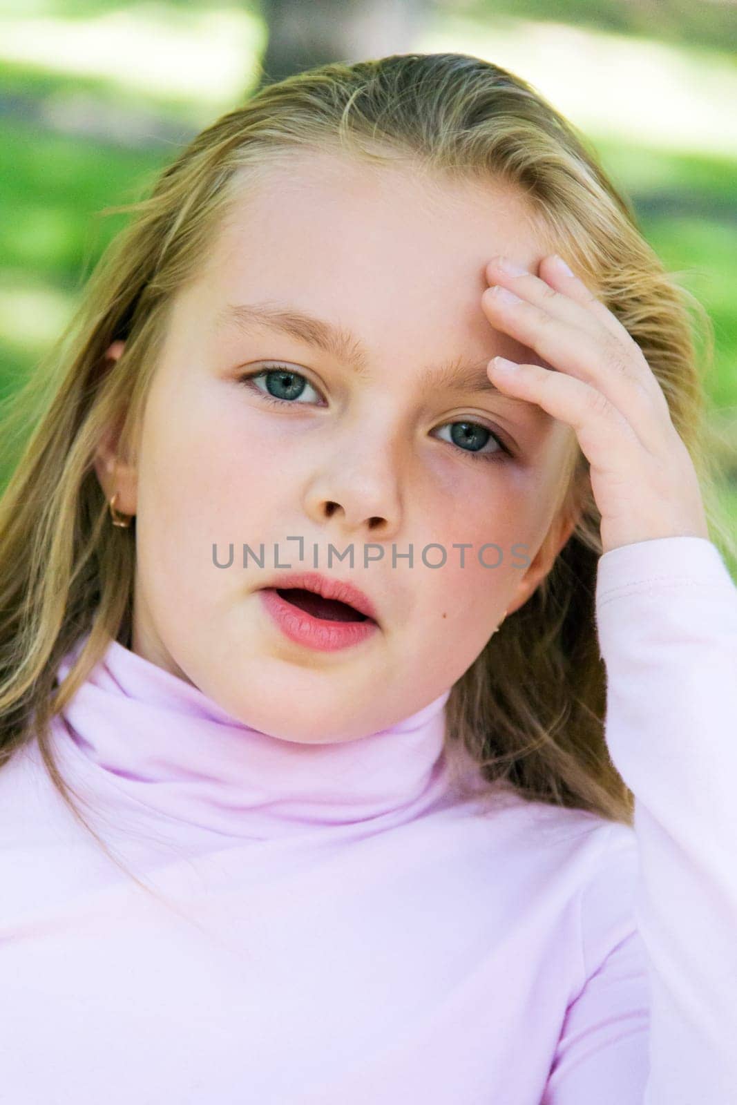 Cute girl with blond long hair and blue eyes