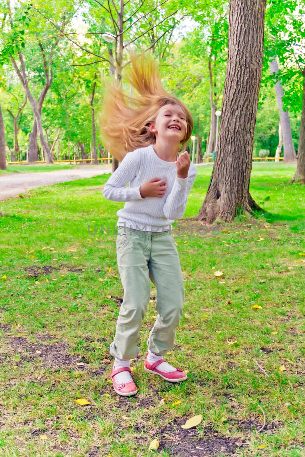 Photo of cute playing girl in summer