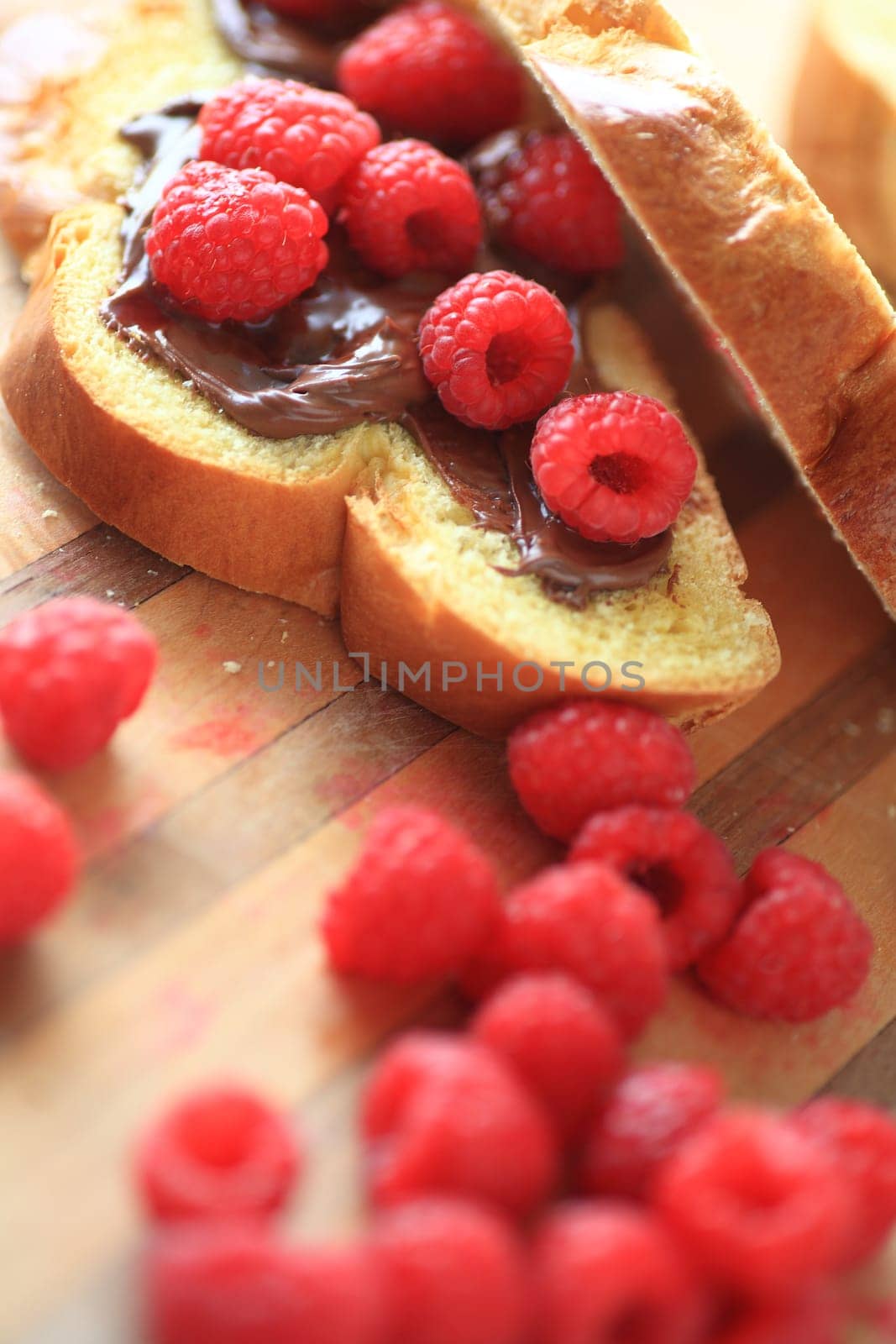 Brioche slices with chocolate spread and fresh raspberries