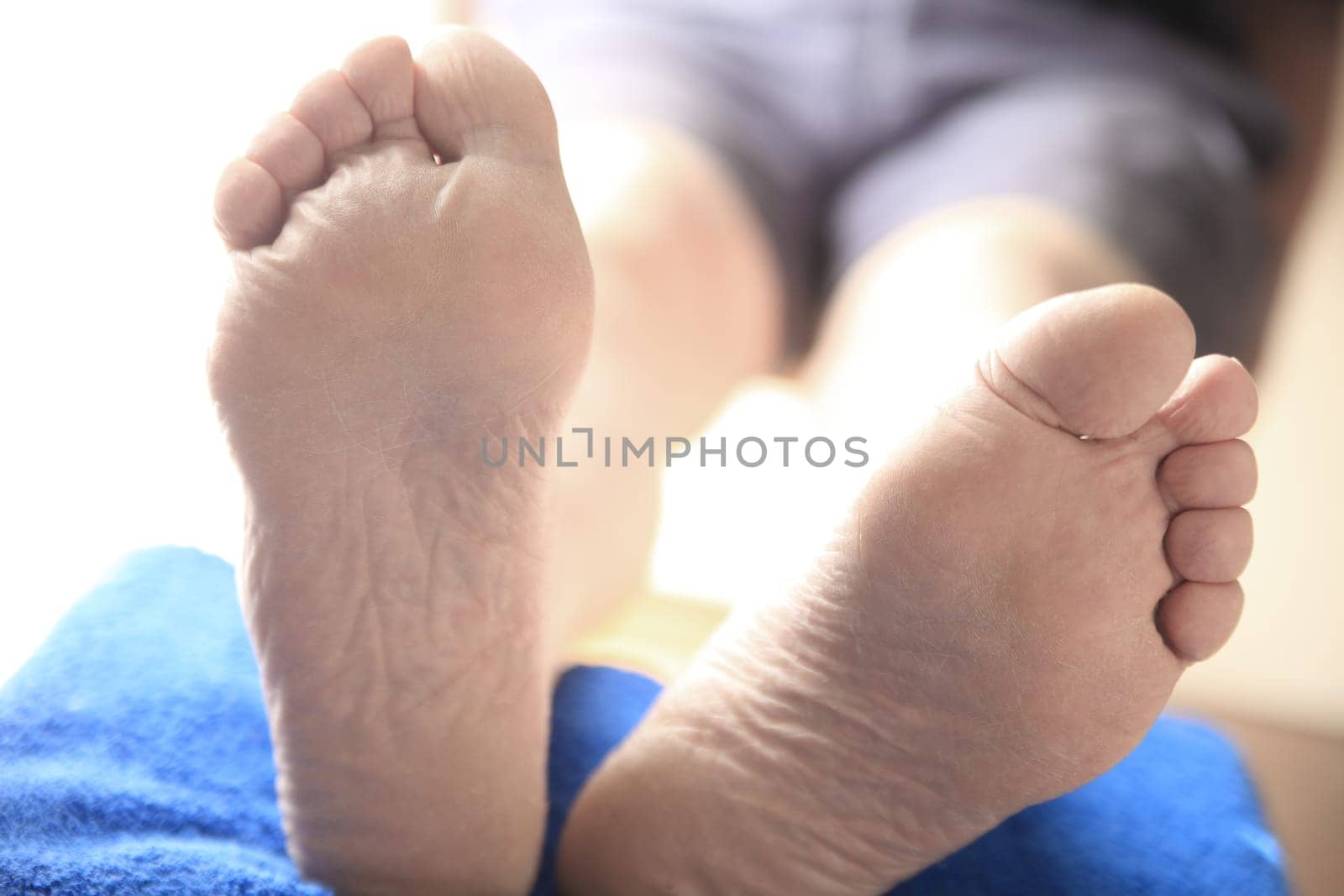 Closeup view of two feet of a man with his legs propped up