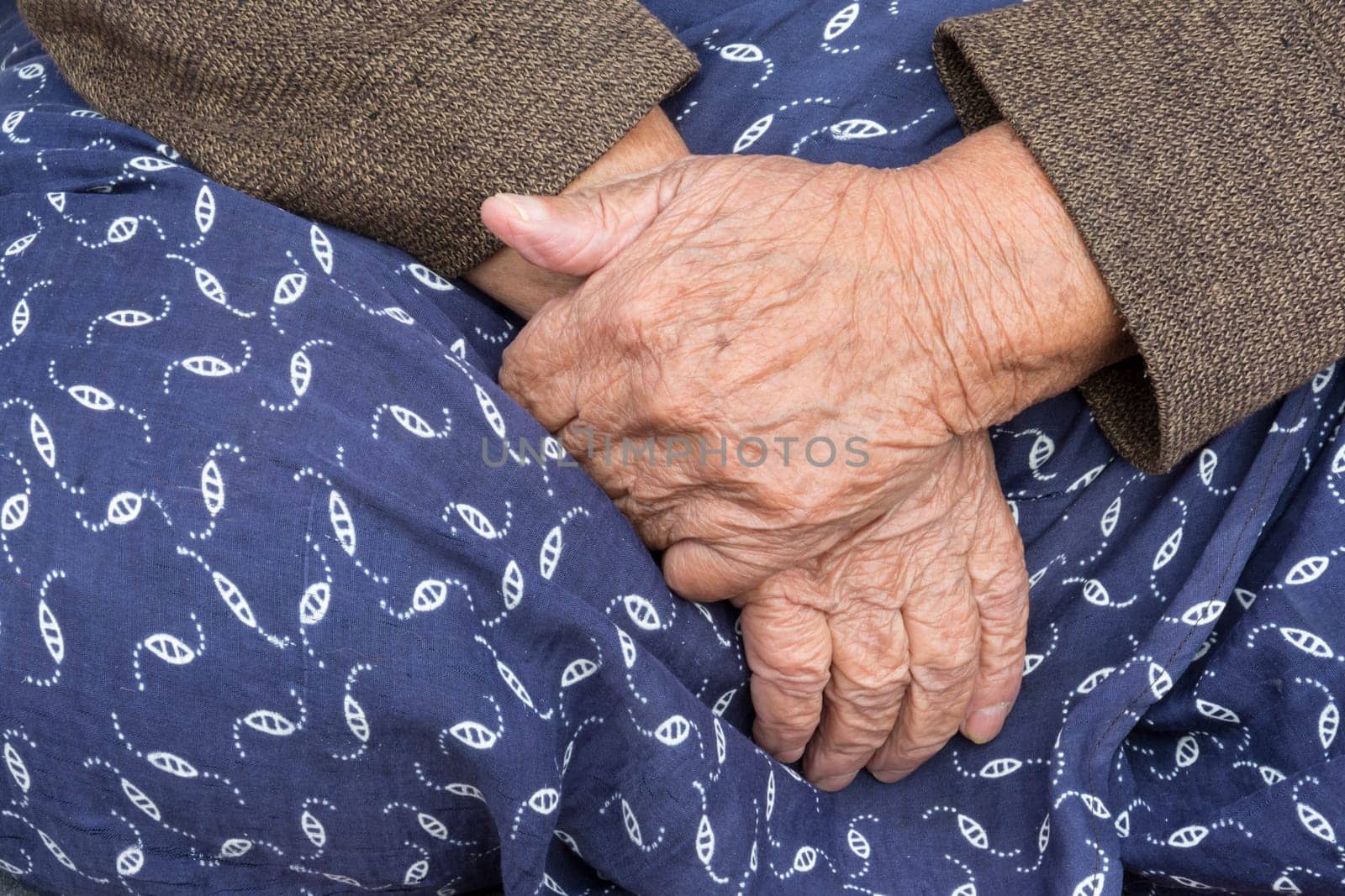 Elderly Womans Hands, A Detail of An Old Woman Hands On Her Traditional Skirt.