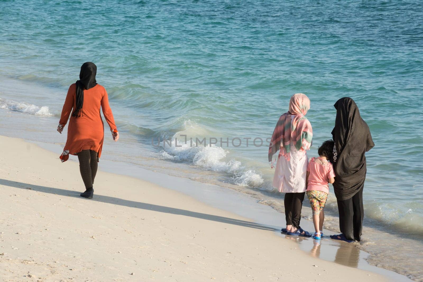 Group of Muslim Women Contemplating and Enjoying Their Time at Beach
